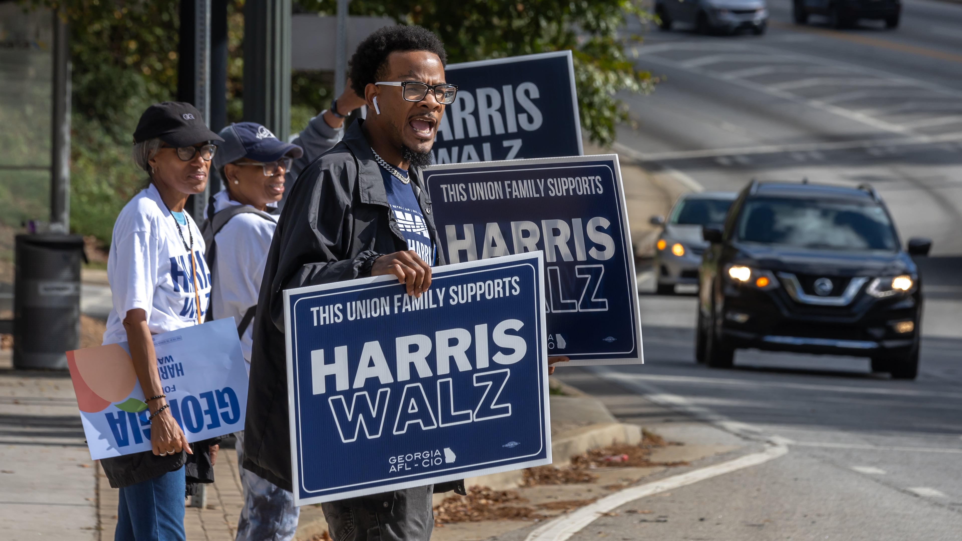 Rasheed Wingo (right), with the Atlanta North Georgia Labor Council, campaigns at the C.T. Martin Natatorium and Recreation Center on Election Day 2024. The state of Georgia was on track to break voter turnout records as presidential candidates, Republican Donald Trump and Democrat Kamala Harris, went head-to-head in this pivotal swing state. (John Spink/AJC 2024)