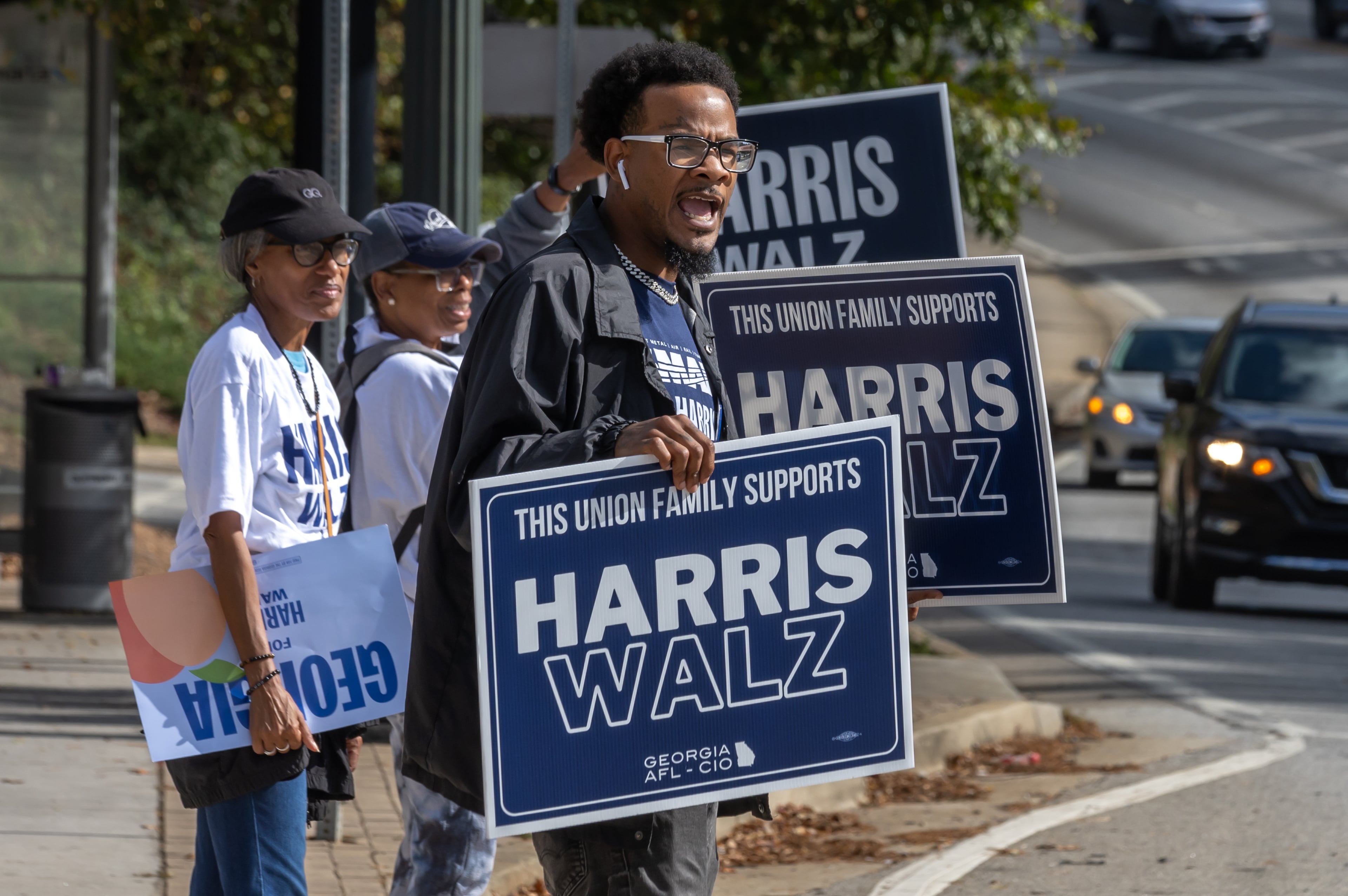 Rasheed Wingo (right), with the Atlanta North Georgia Labor Council, campaigns at the C.T. Martin Natatorium and Recreation Center on Election Day 2024. The state of Georgia was on track to break voter turnout records as presidential candidates, Republican Donald Trump and Democrat Kamala Harris, went head-to-head in this pivotal swing state. (John Spink/AJC 2024)