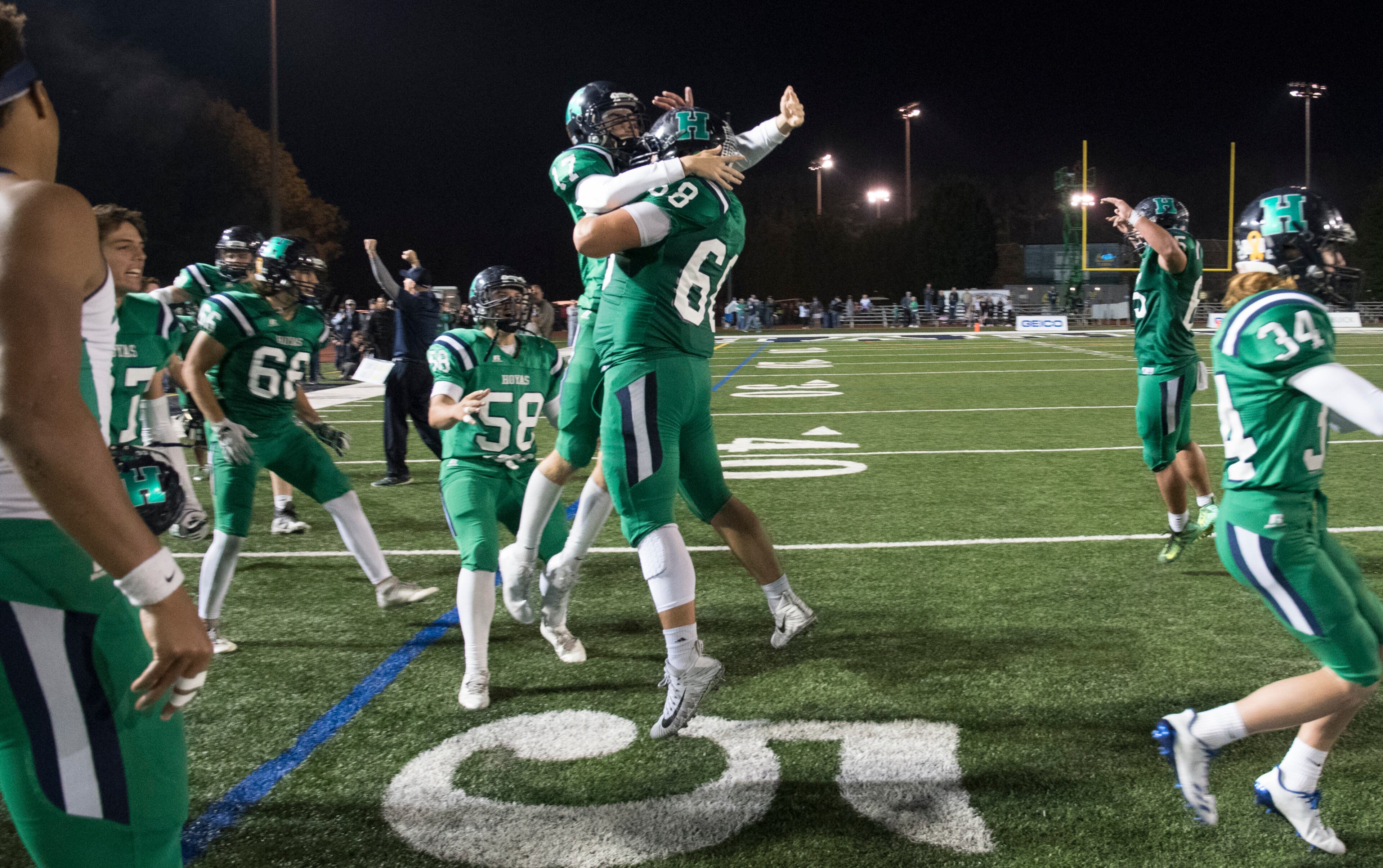 dHarrison's Cooper Guilotte (17) and Andrew Waller (68) celebrate after winning 28-26 during a high school football game against Dalton on Thursday, Oct. 19, 2017, in Kennesaw, Ga. (Special to the Atlanta Journal-Constitution, John Amis )