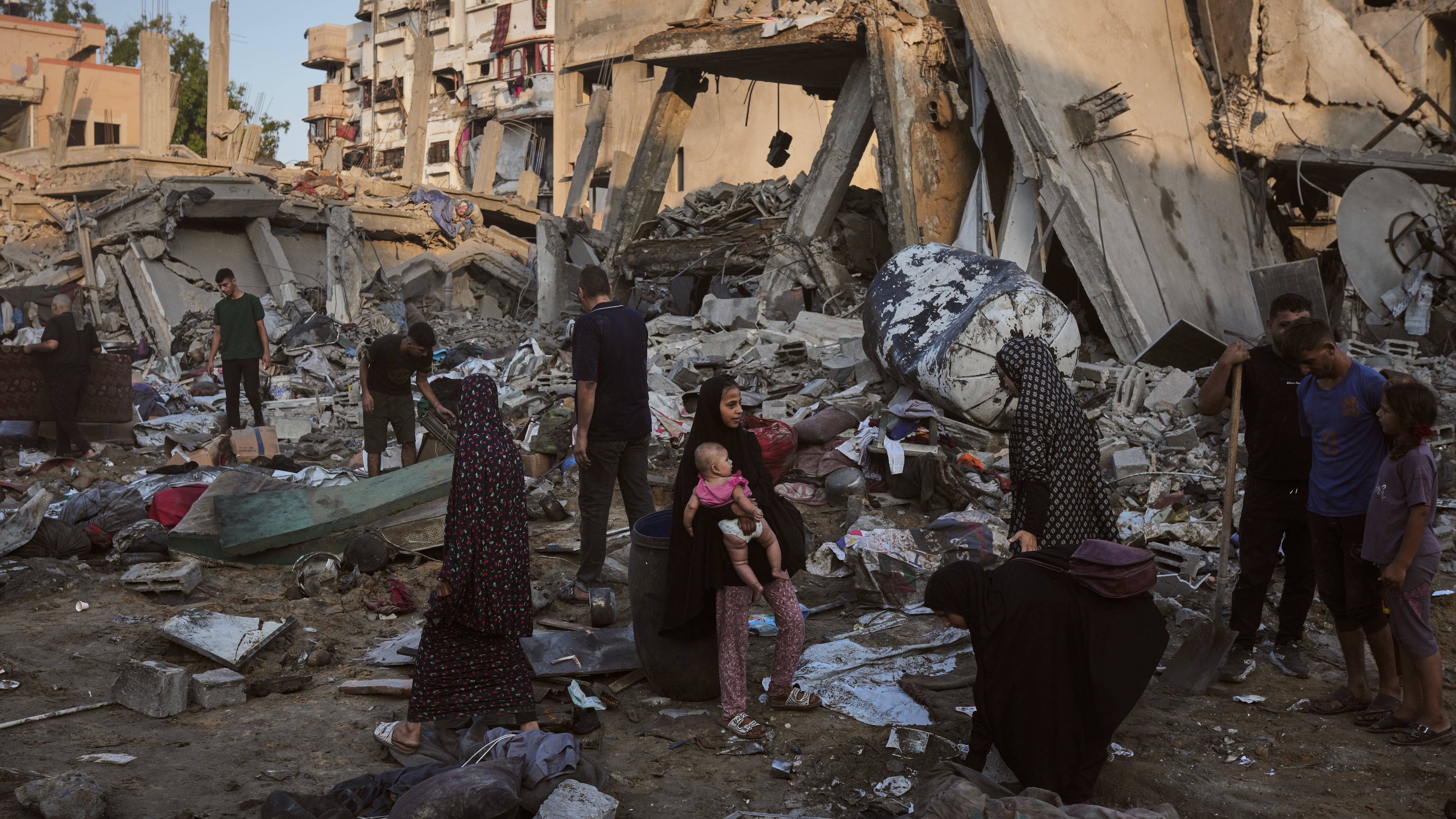 Palestinians salvage their belongings from the rubble of a building and tents destroyed in an Israeli airstrike in Gaza City, Thursday, July 30, 2026. (AP Photo/Jehad Alshrafi)