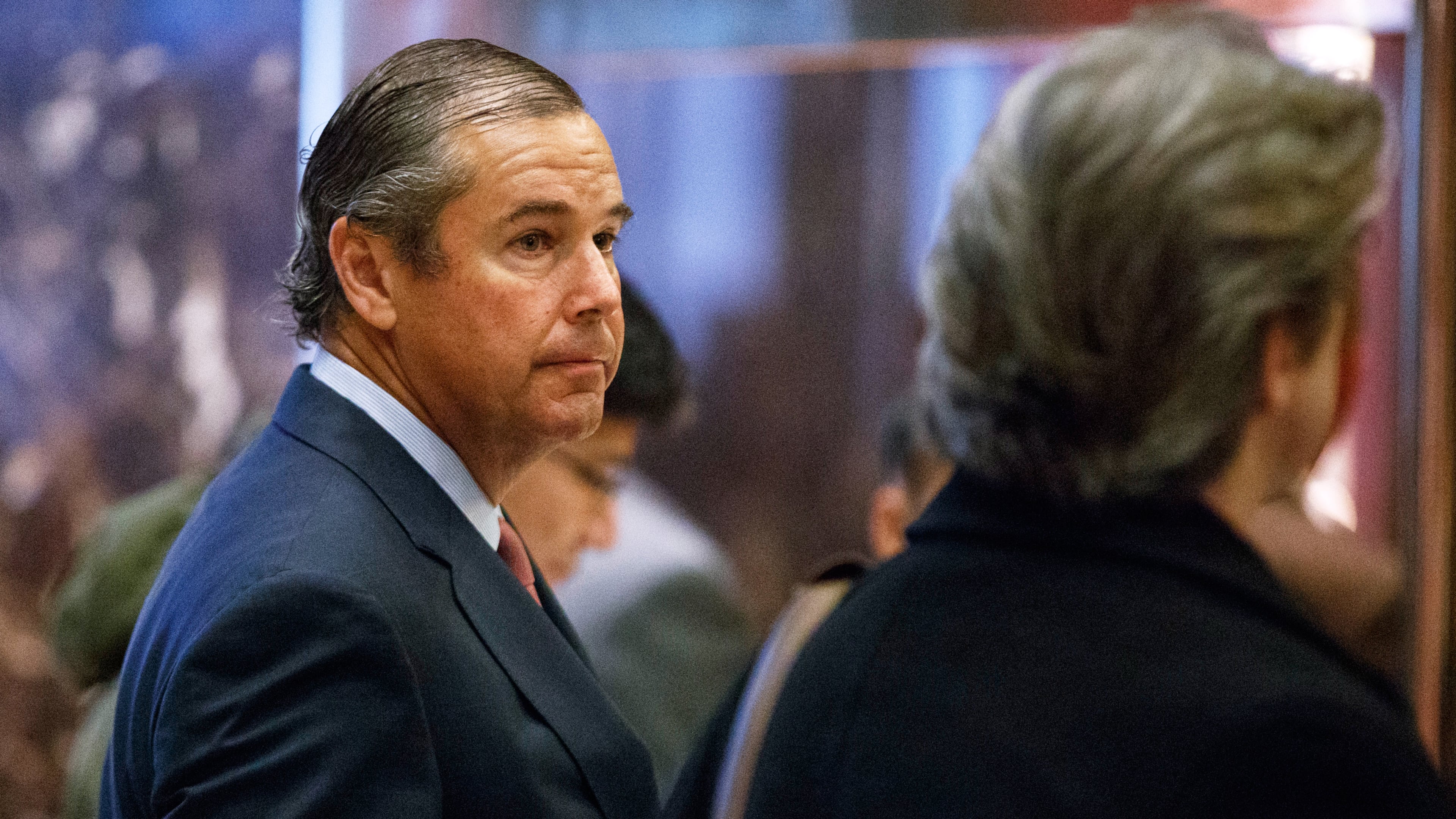 FILE - Ray Washburne waits for an elevator in the lobby of Trump Tower in New York on Nov. 30, 2016. (AP Photo/Evan Vucci, File)