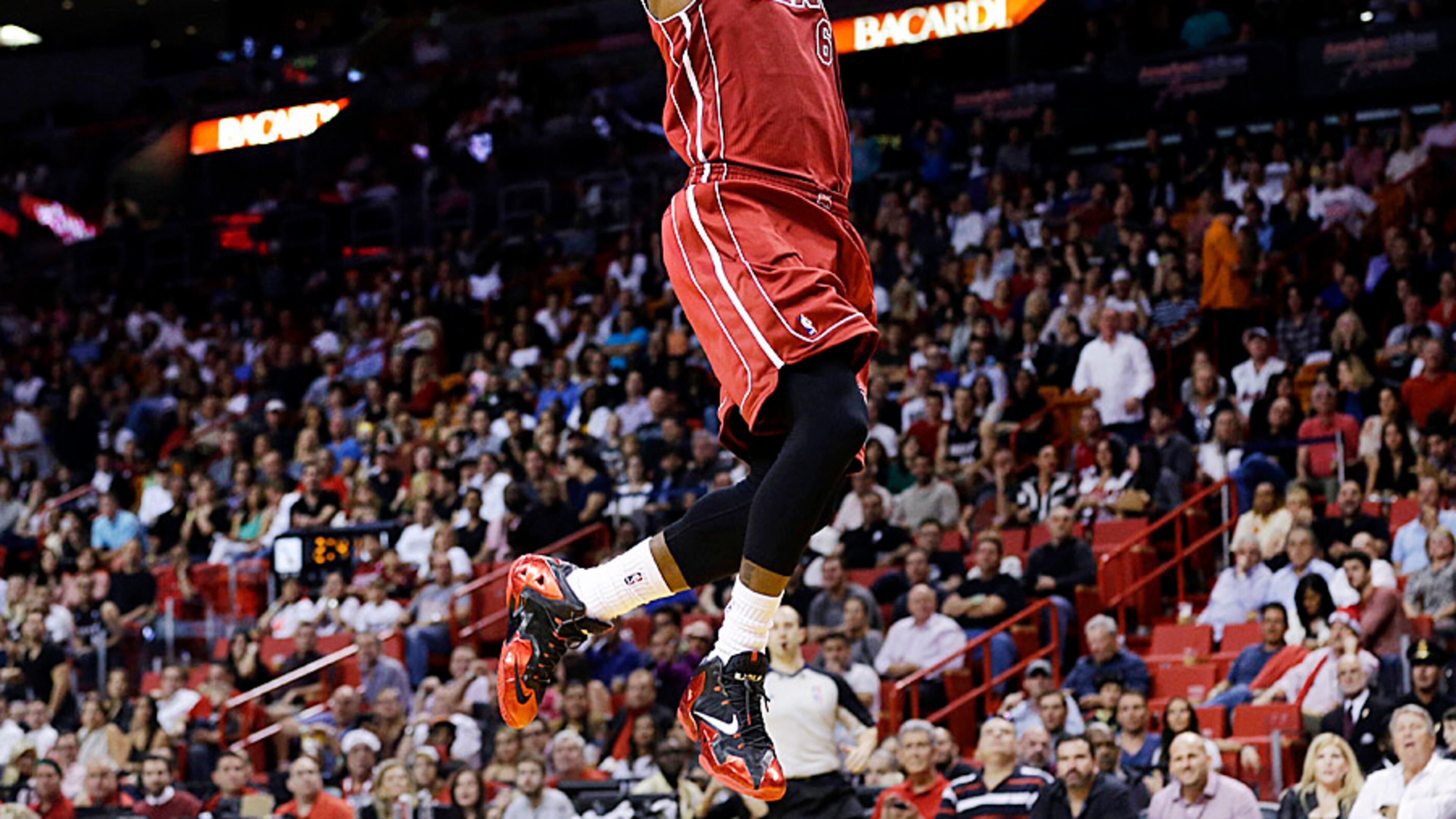 Miami Heat's LeBron James goes up to dunk in the first half of an NBA basketball game against the Sacramento Kings, Friday, Dec. 20, 2013, in Miami. (AP Photo/Lynne Sladky)