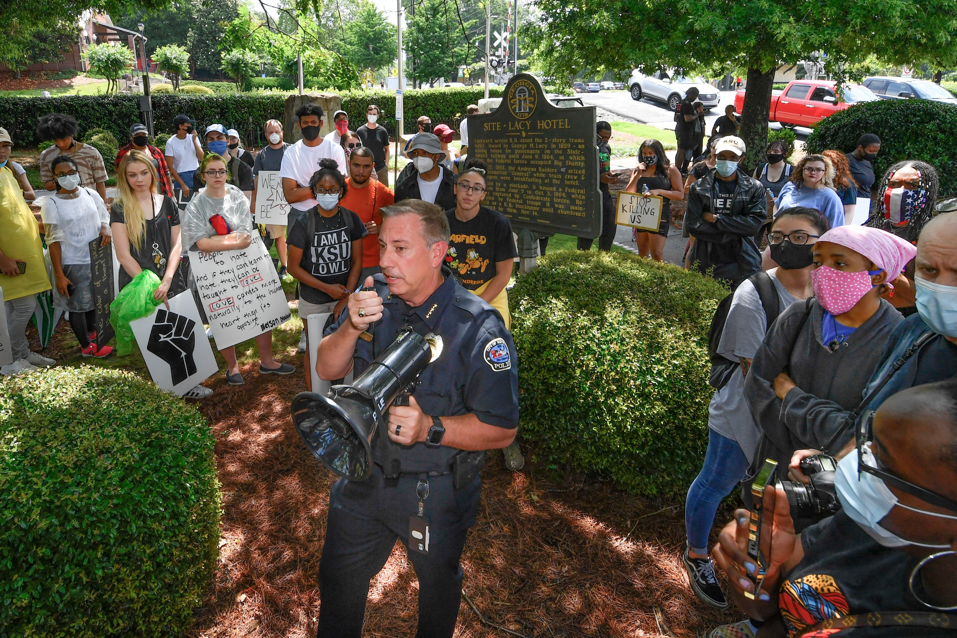Kennesaw Police Chief Bill Westenberger speaks to a group of demonstrates across the street from a Confederate-era memorabilia shop, during a protest held Friday, June 5, in Kennesaw. JOHN AMIS FOR THE ATLANTA JOURNAL-CONSTITUTION