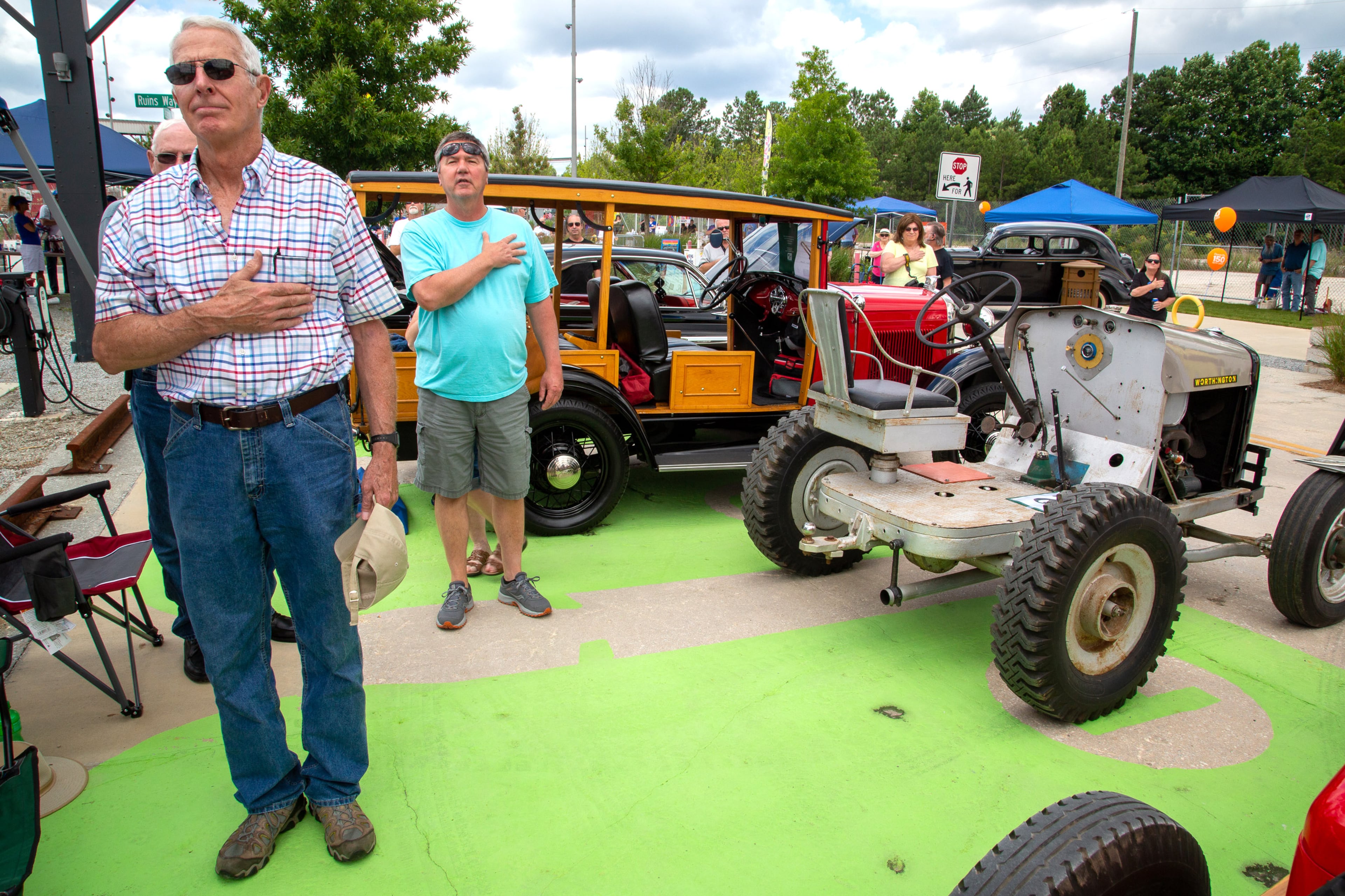 John Maloney (left) stands with his hand over his heart during the Star-Spangled Banner during the Doraville Car Show along Assembly Line Drive on Saturday, June 26, 2021. (Photo: Steve Schaefer for The Atlanta Journal-Constitution)
