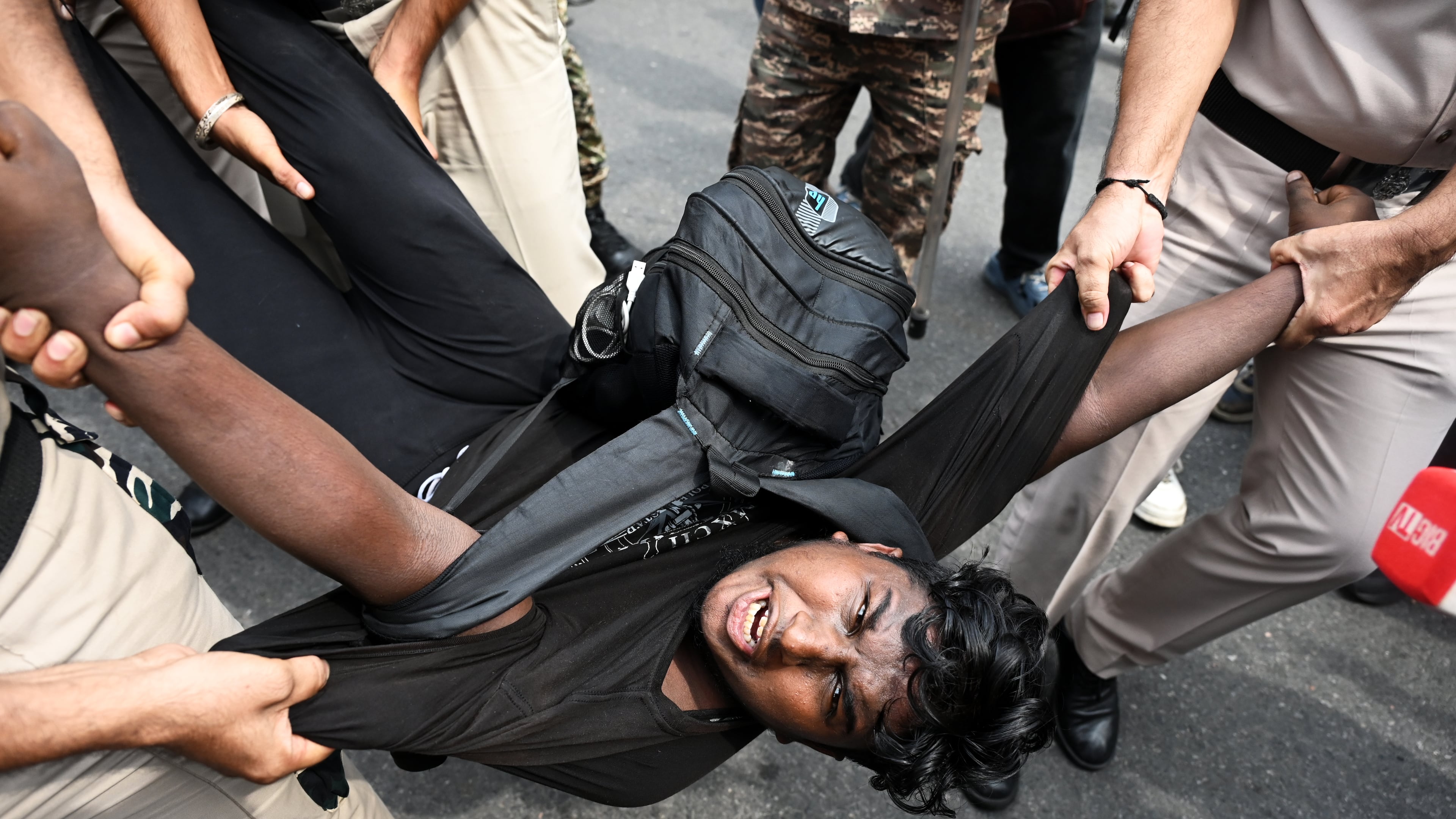 Security personnel detain a protester during a youth demonstration demanding the resignation of the country's election chief Gyanesh Kumar, in New Delhi, India, Sunday, Oct. 11, 2026. (AP Photo/Vipin)