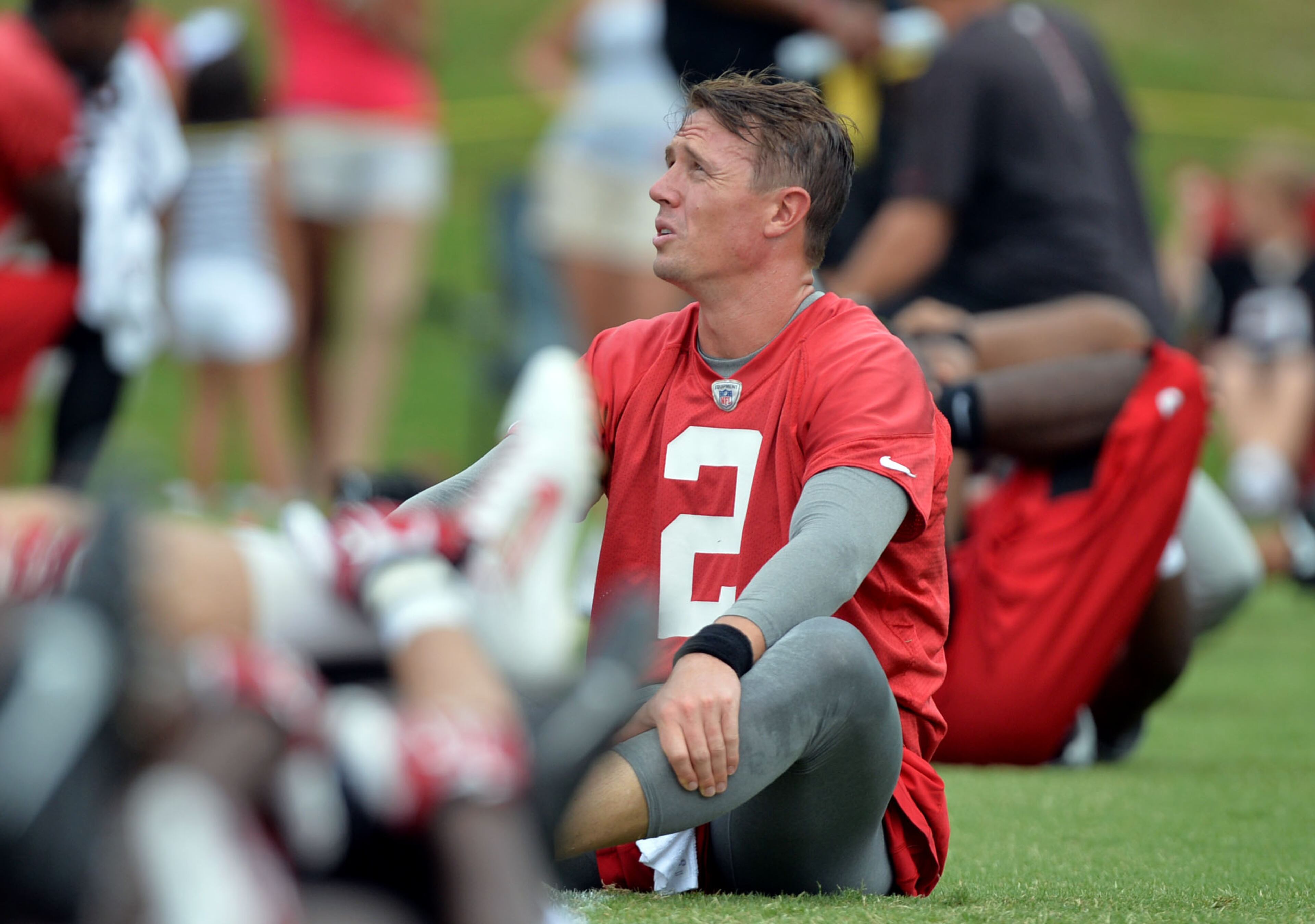 Falcons QB Matt Ryan stretches during the mini-camp. Atlanta Falcons players workout during the second day of mini-camp at the team's facilities in Flowery Branch, Wednesday, June 18, 2014. KENT D. JOHNSON/KDJOHNSON@AJC.COM