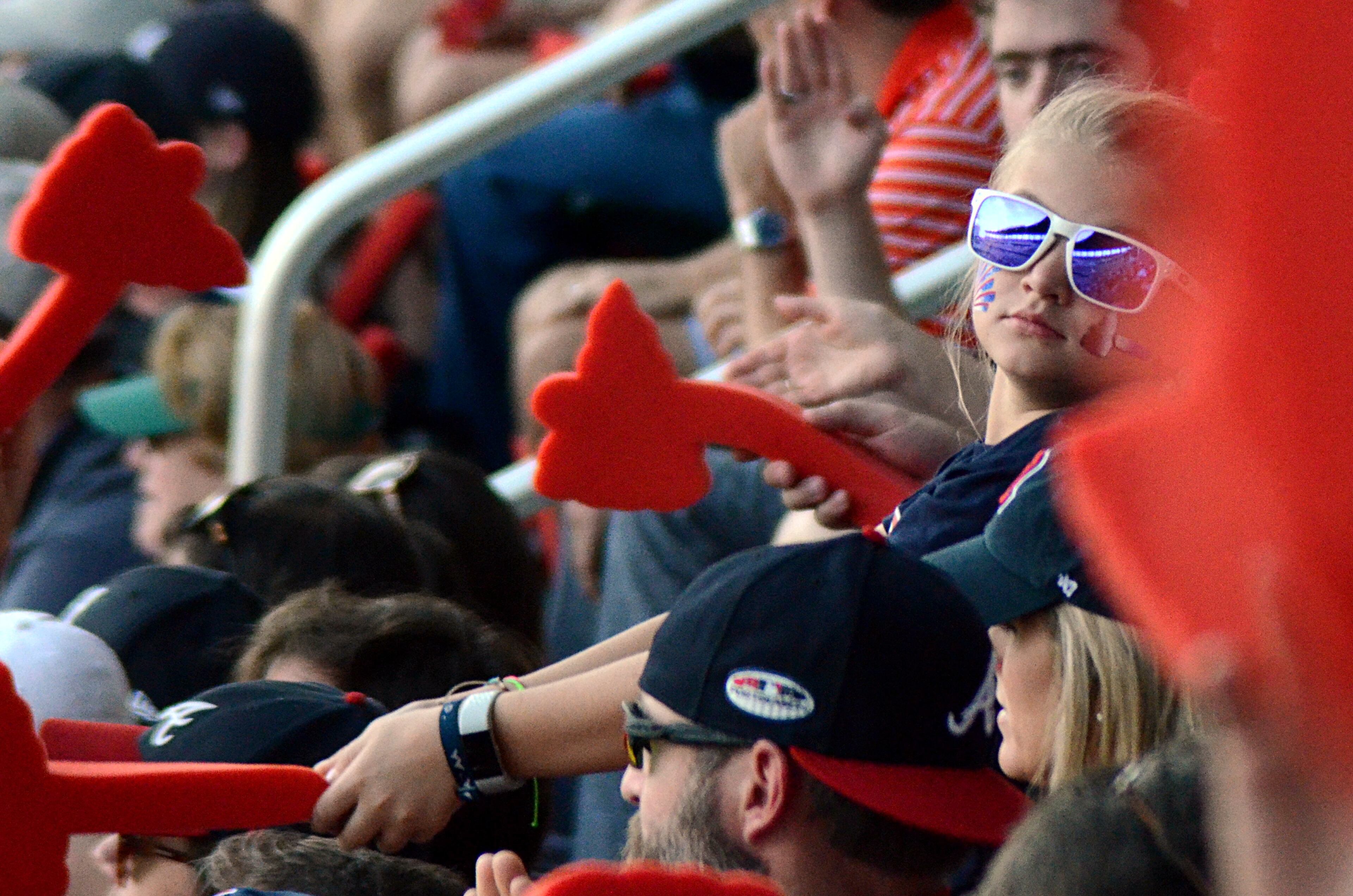 A young Atlanta Braves fan does the "Tomahawk Chop" on Monday, Oct. 8, 2018 at SunTrust Park. The Braves faced the Dodgers in Game Four of the NLDS.