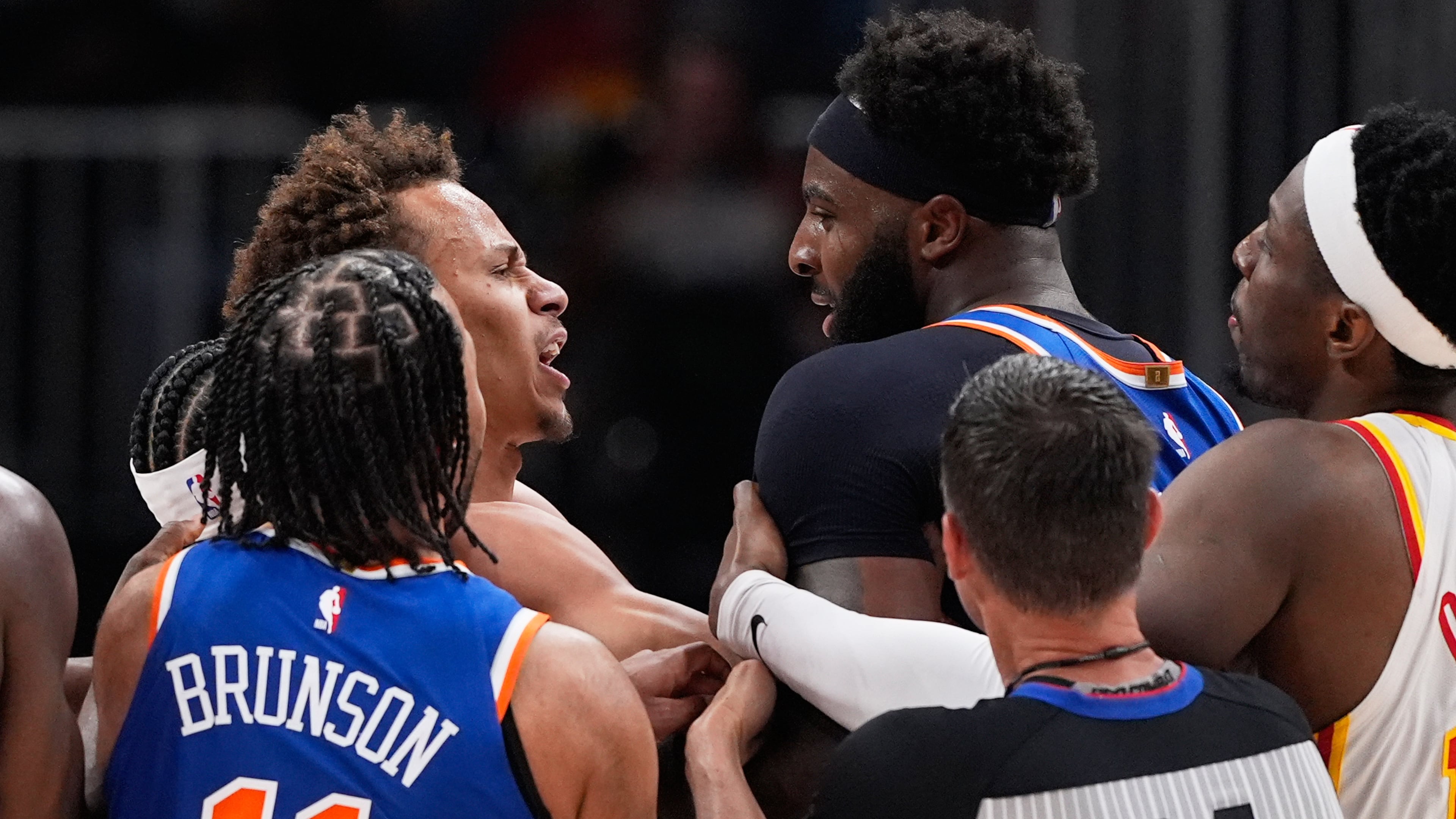 New York Knicks center Mitchell Robinson (23) and Atlanta Hawks guard Dyson Daniels (5) fight in the first half during Game 6 in a first-round NBA basketball playoffs series Thursday, April 30, 2026, in Atlanta. (AP Photo/Brynn Anderson)