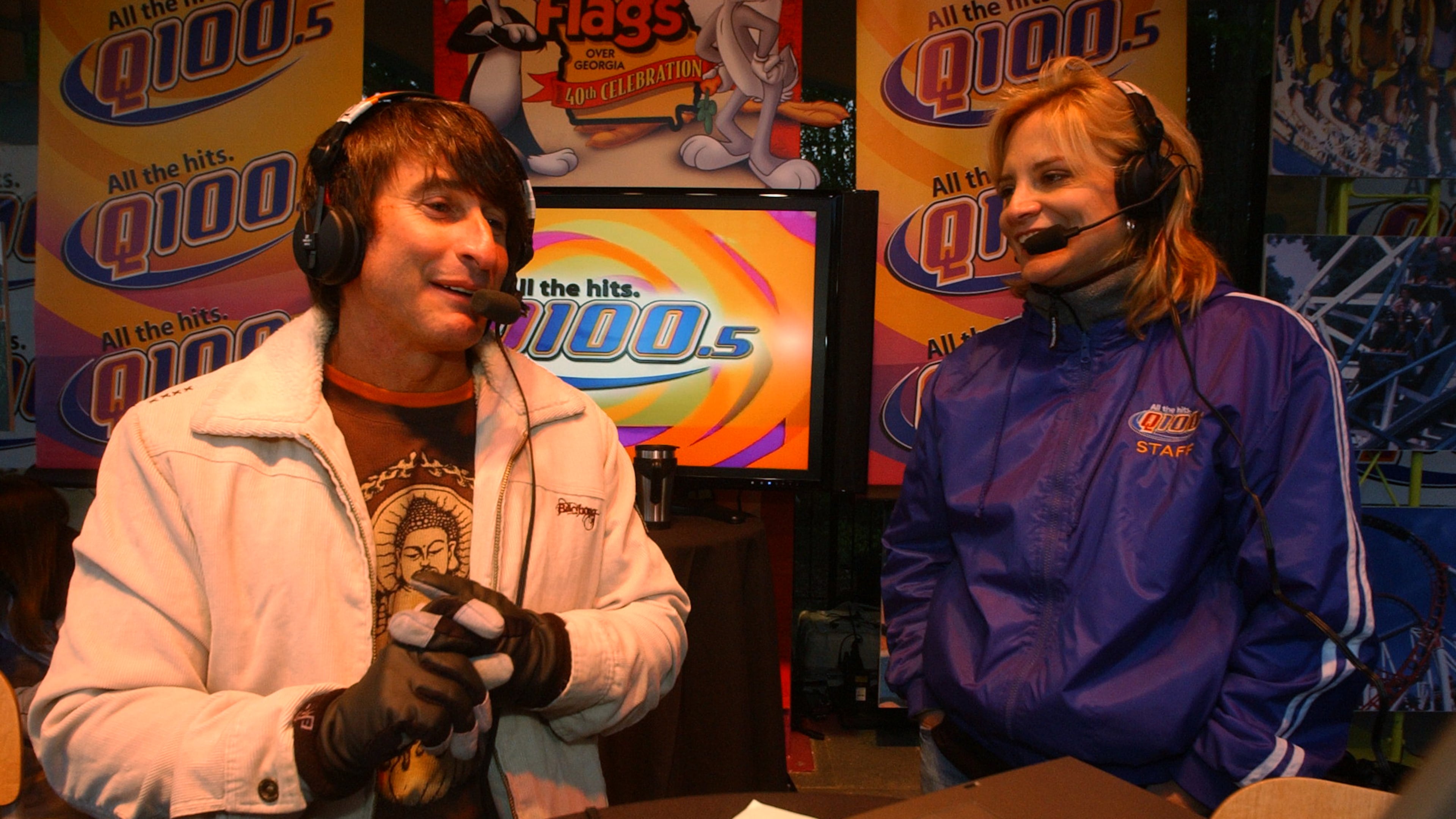 070405 - ATLANTA, GA -- Bert Weiss), left, of the Q100 radio Bert Show and Melissa Carter, right, also of the Bert Show, host the radio show from Six Flags Over Georgia Thursday, April 5, 2007. The park was open for free for the radio station promotion that drew thousands more people than were expected, causing snarled traffic and many people who were turned away when the park reached its capacity at 5:50 am and no more people were allowed in. Some people arrived as early as 2 am to get in free. (Kimberly Smith / AJC staff)