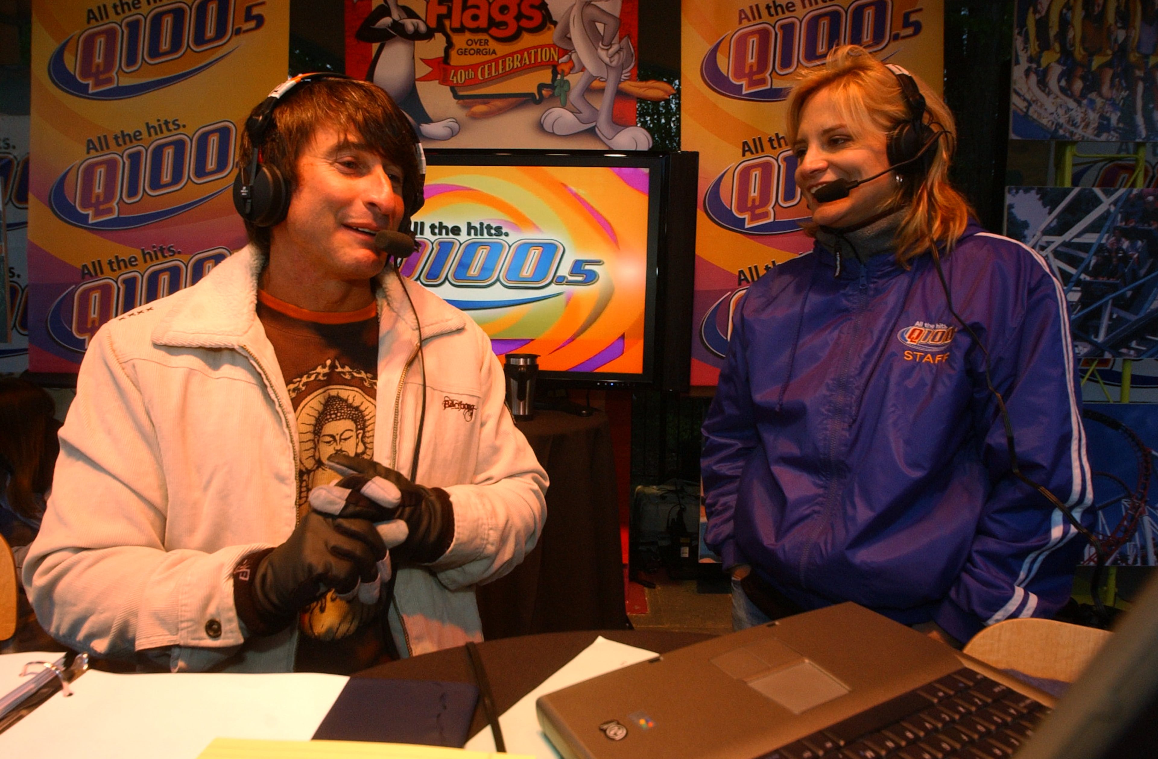 070405 - ATLANTA, GA -- Bert Weiss), left, of the Q100 radio Bert Show and Melissa Carter, right, also of the Bert Show, host the radio show from Six Flags Over Georgia Thursday, April 5, 2007. The park was open for free for the radio station promotion that drew thousands more people than were expected, causing snarled traffic and many people who were turned away when the park reached its capacity at 5:50 am and no more people were allowed in. Some people arrived as early as 2 am to get in free. (Kimberly Smith / AJC staff)
