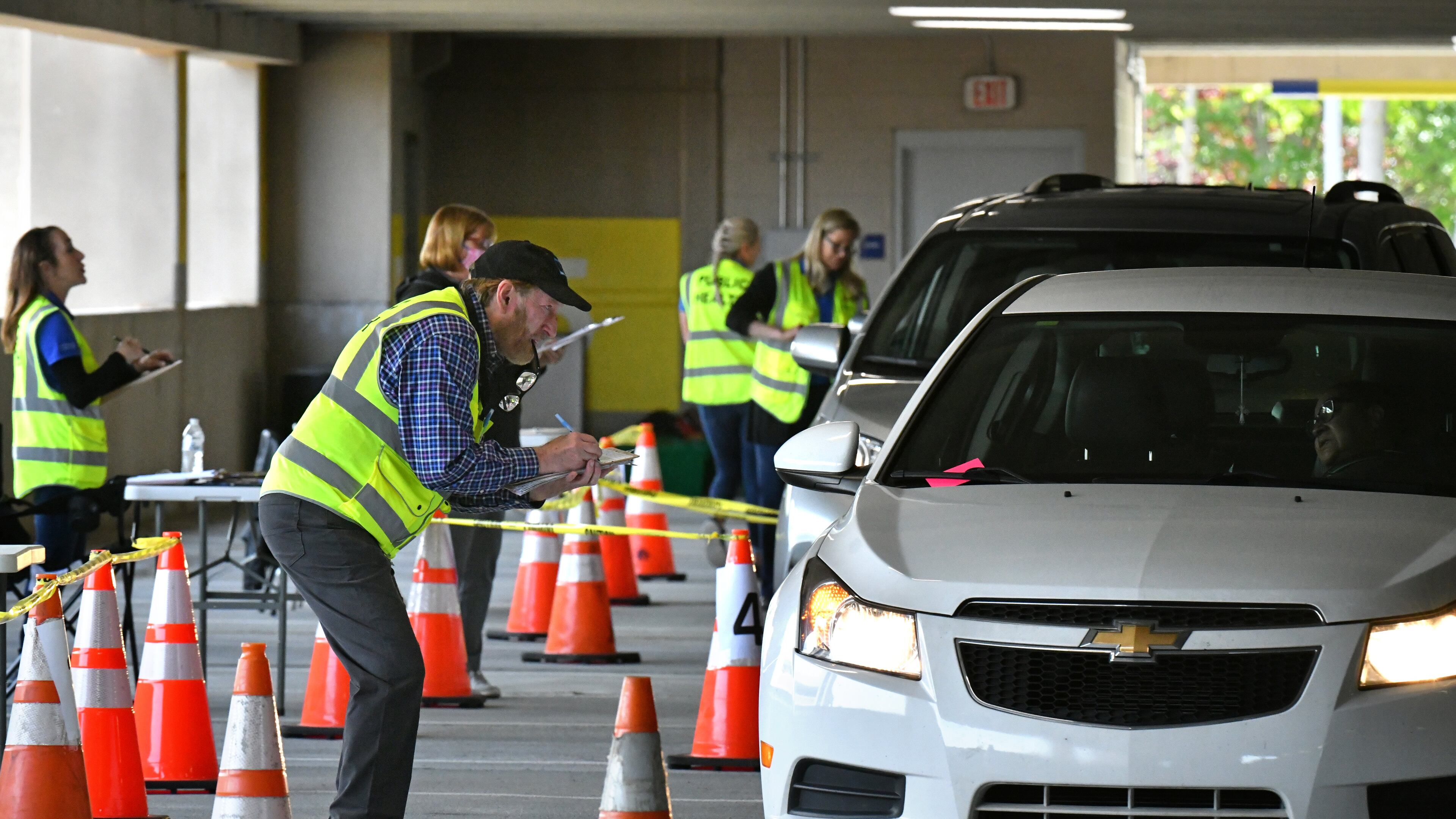April 22, 2020 Duluth - Health care workers help potential COVID-19 patients with their paperworks at a drive-through COVID-19 testing site for anyone who is experiencing symptoms at the Infinite Energy Center in Duluth on Wednesday, April 22, 2020. A drive-through COVID-19 testing center is open in Gwinnett County for anyone who is experiencing symptoms â with no doctorâs orders necessary. The Gwinnett, Newton and Rockdale County Health Department conducted 800 tests at the event venue, its second large-scale testing event in a week. (Hyosub Shin / Hyosub.Shin@ajc.com)