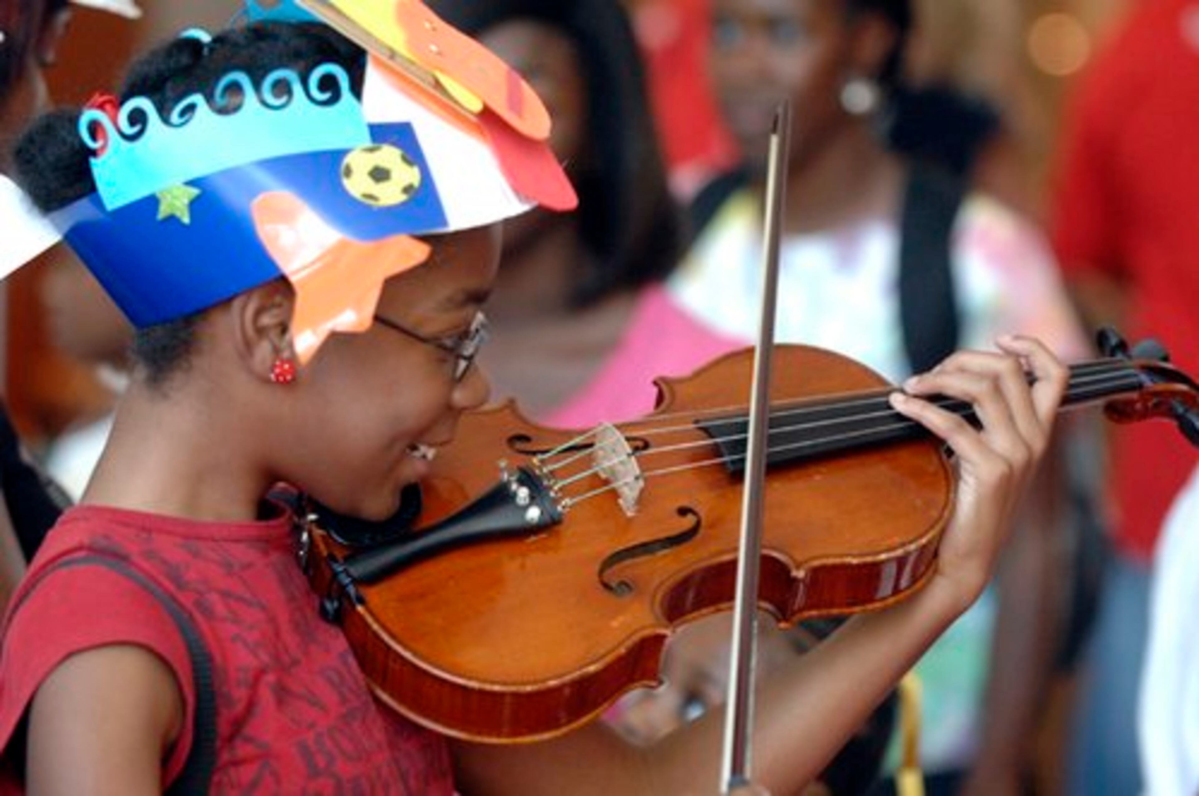 Mercedes Johnson, 10,of Lithonia, tries out a violin during a "petting zoo" of various instruments sponsored by the Atlanta Symphony during the Target Family Fun Day at the Woodruff Arts Center Sunday afternoon. Kent D. Johnson, kdjohnson@ajc.com