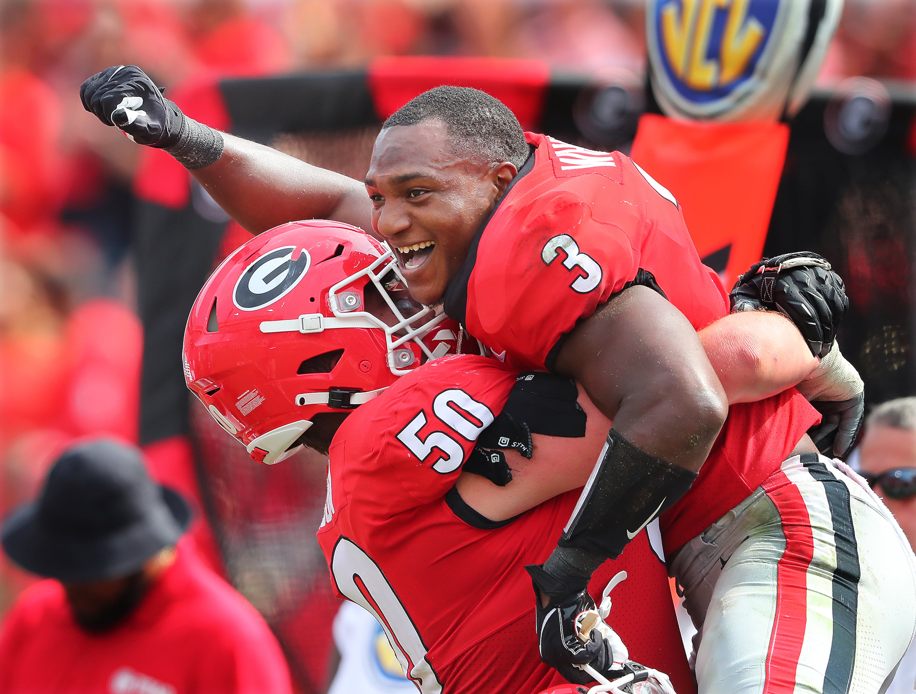 Georgia tailback Zamir White celebrates his second touchdown on the day getting a hoist from offensive lineman Warren Ericson for a 34-0 lead over Arkansas during the 4th quarter in a NCAA college football game on Saturday, Oct. 2, 2021, in Athens. Georgia shut out Arkansas 37-0. “Curtis Compton / Curtis.Compton@ajc.com”