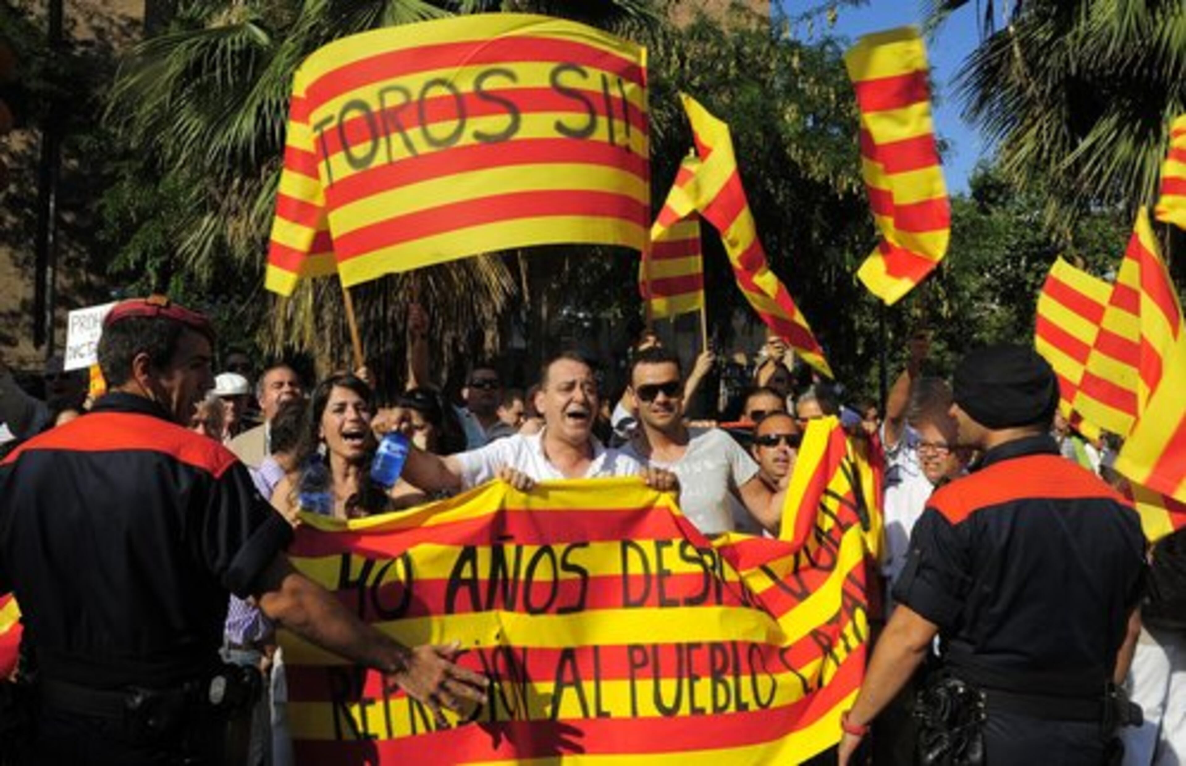 People shout slogans in favor of bullfights outside Barcelona's bullring in Barcelona, Spain.