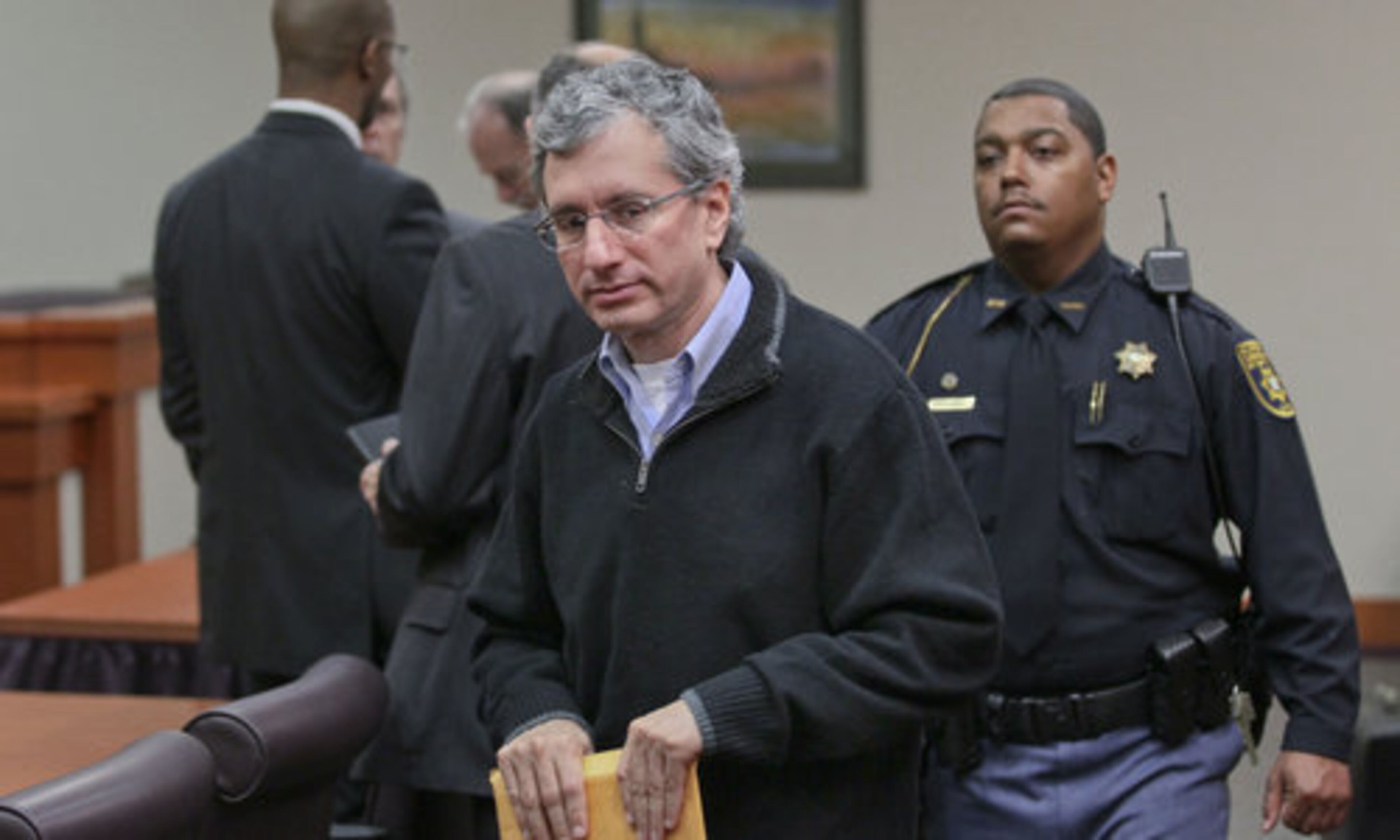 Defendant, Hemy Neuman exits the courtroom after the jury had been dismissed to deliberate Wednesday in the courtroom.