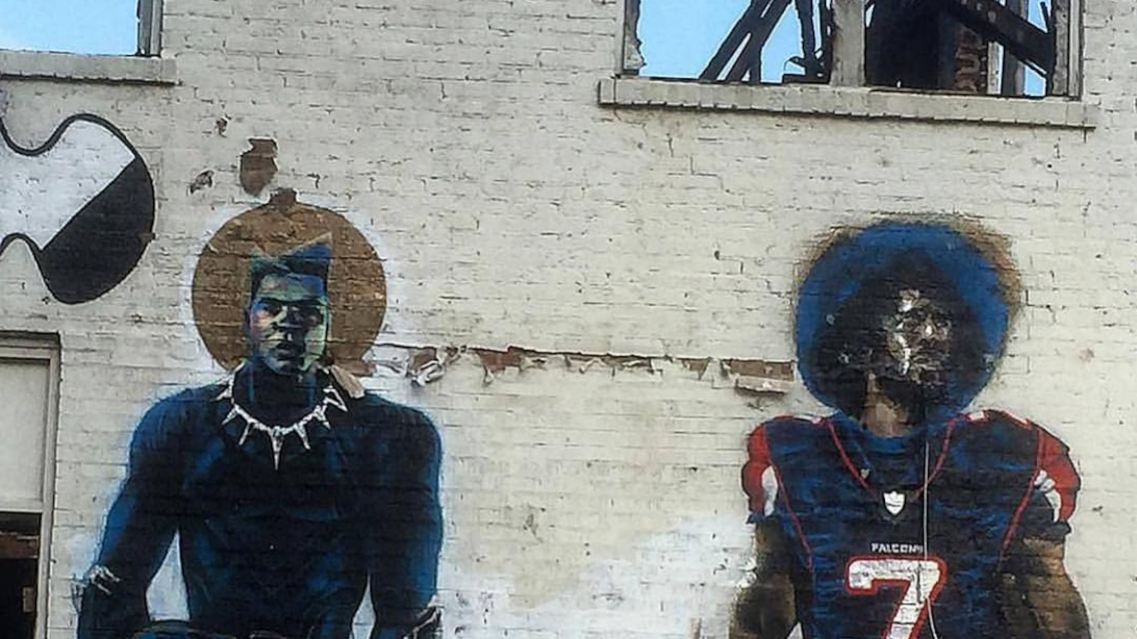 An Atlanta child admires the mural of Colin Kaepernick and Muhammad Ali, when it was on the side of a building on Fair Street and Joseph E. Lowery Boulevard.