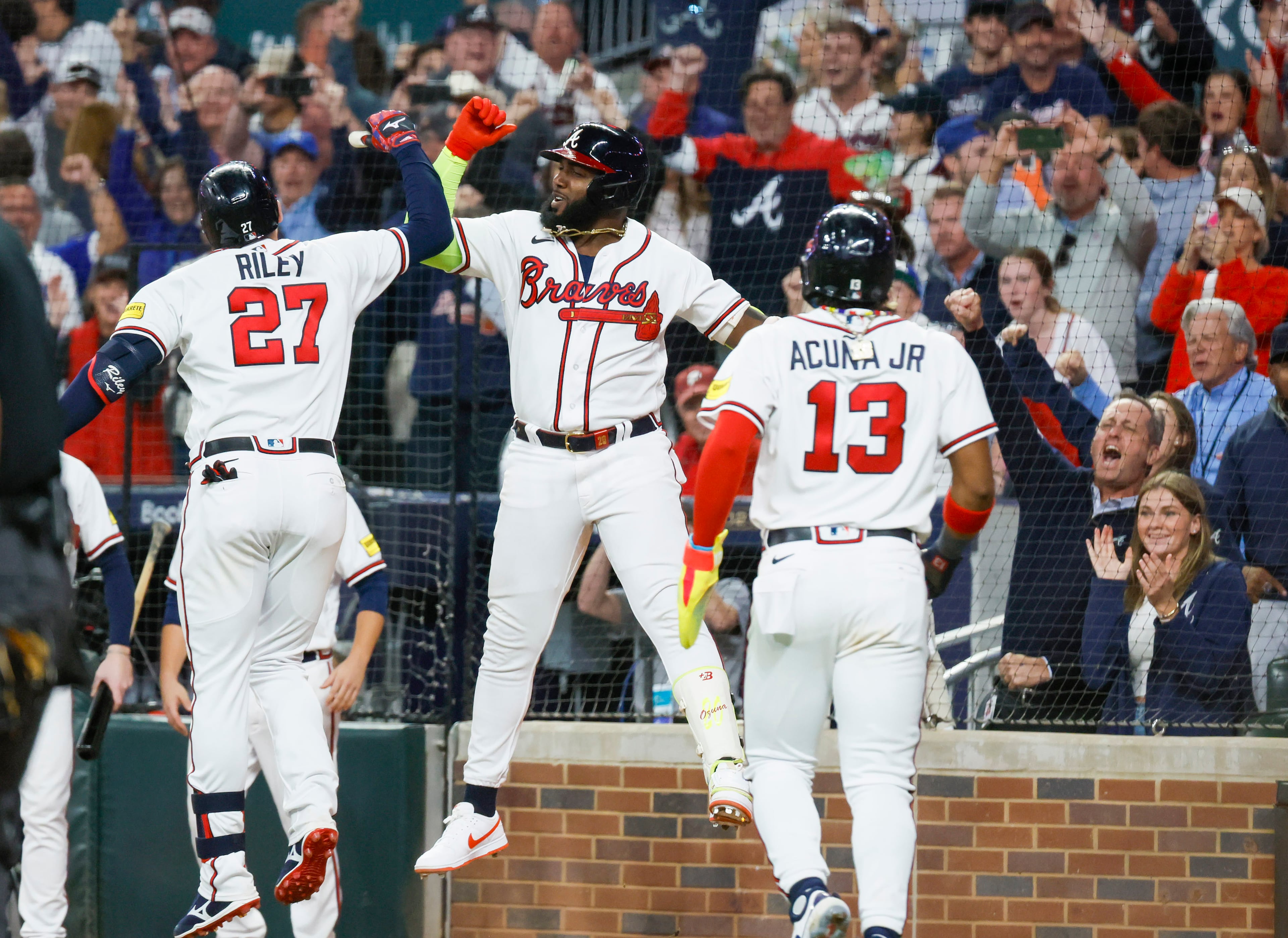 Atlanta Braves third baseman Austin Riley (27) celebrates after a two-run home run against the Philadelphia Phillies during the eighth inning of NLDS Game 2 in Atlanta on Monday, Oct. 9, 2023. (Miguel Martinez / Miguel.Martinezjimenez@ajc.com)