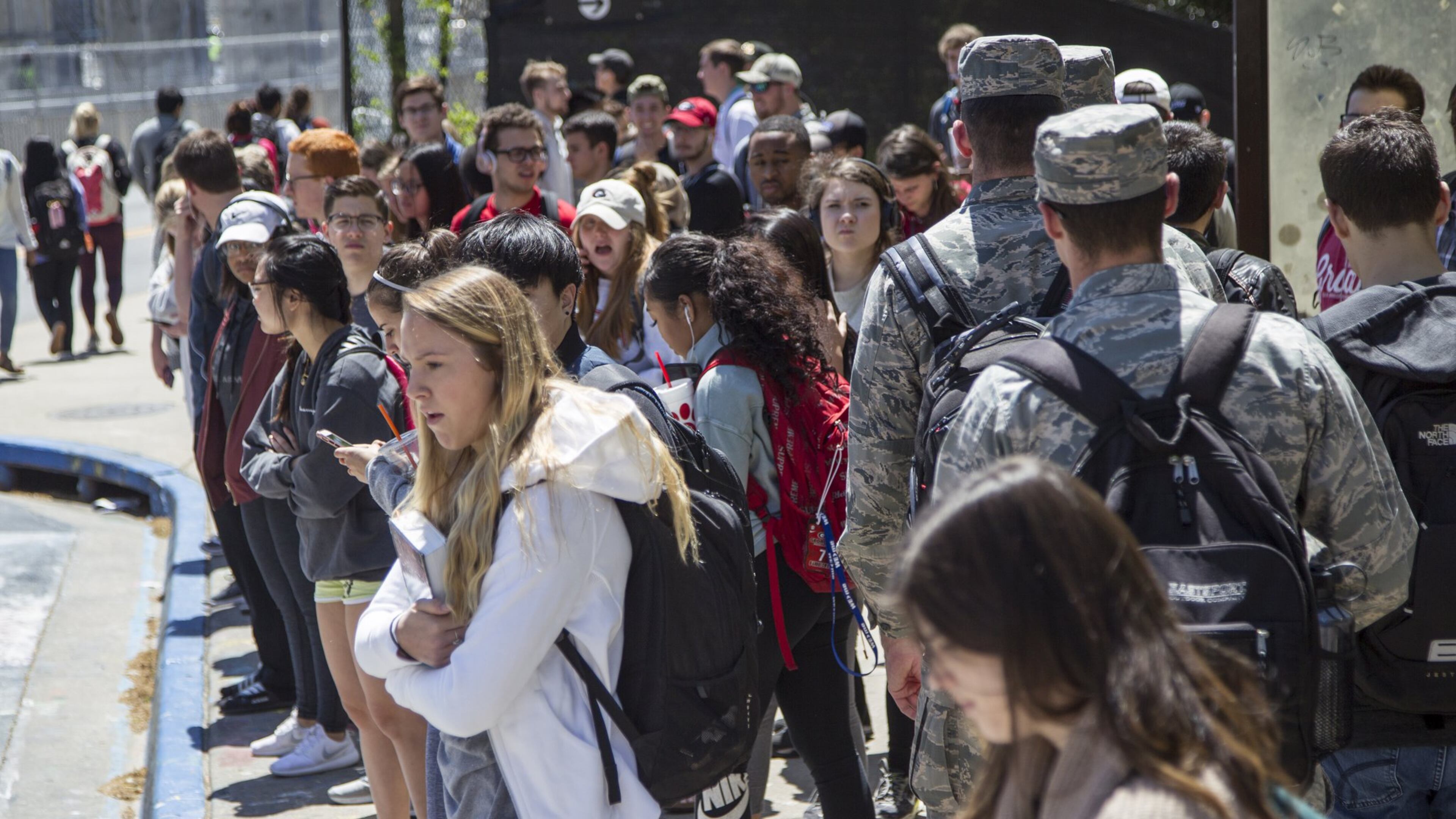 University of Georgia students wait for buses at the Tate Student Center bus stop on the University of Georgia campus in Athens, Georgia, on Tuesday, April 17, 2018. (REANN HUBER/REANN.HUBER@AJC.COM)