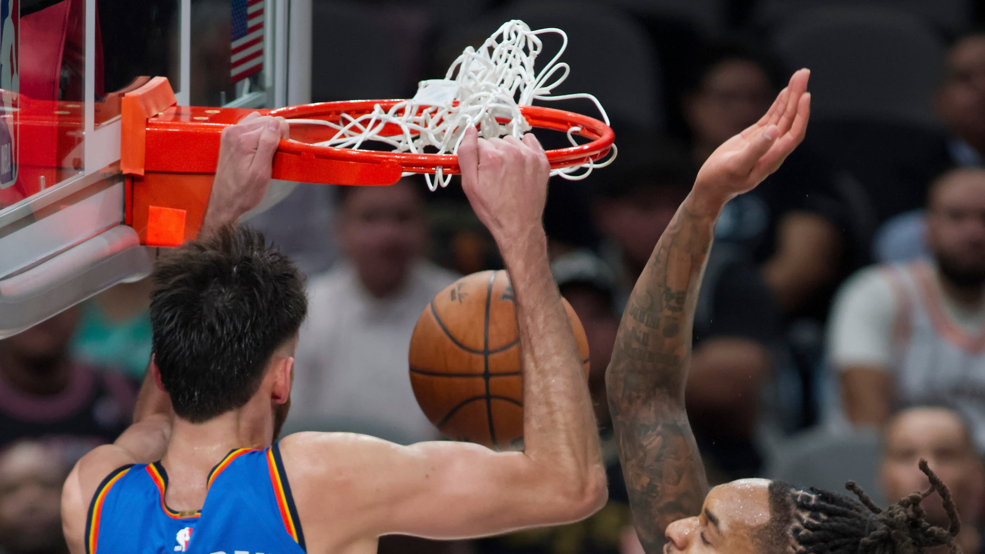 Oklahoma City Thunder center Chet Holmgren (7) dunks against San Antonio Spurs guard Devin Vassell during the first half of an NBA basketball game, Tuesday, Oct. 20, 2026, in San Antonio. (AP Photo/Darren Abate)