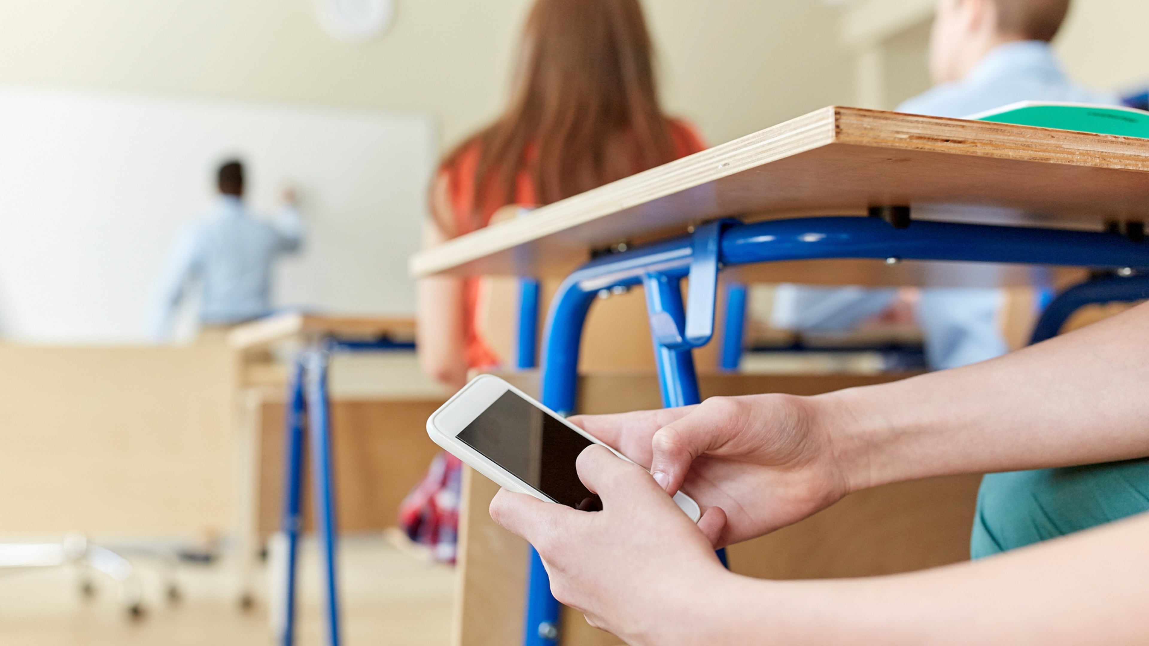 Schools have realized they’ve lost the battle for student attention to the ubiquitous smartphone. Yet many hesitate to ban the phones outright. (Dreamstime/TNS)