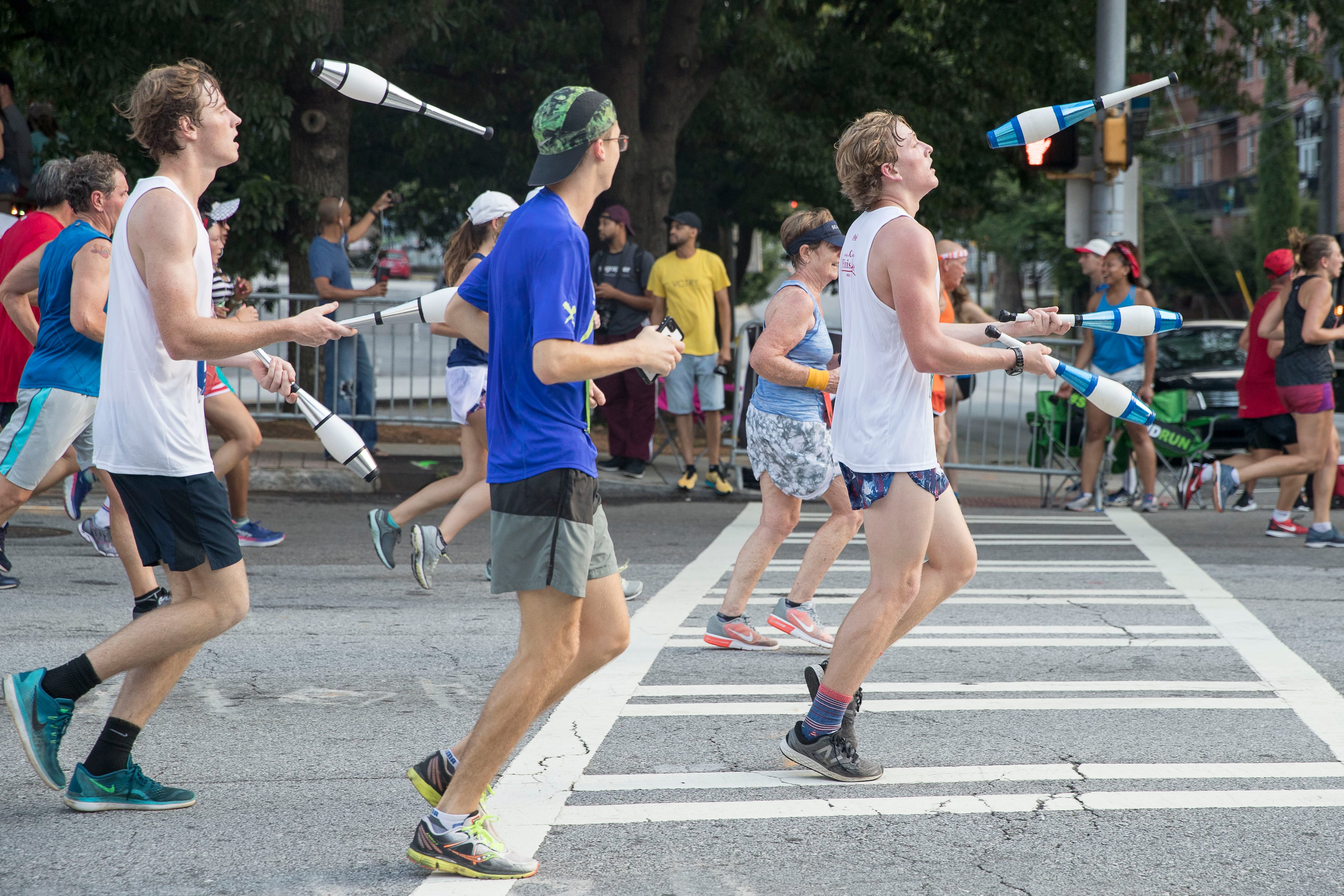 07/04/2018 -- Atlanta, GA -A group of juggling men participate during the 49th running of the AJC Peachtree road race near Piedmont Park, Wednesday, July 4, 2018. ALYSSA POINTER/ALYSSA.POINTER@AJC.COM