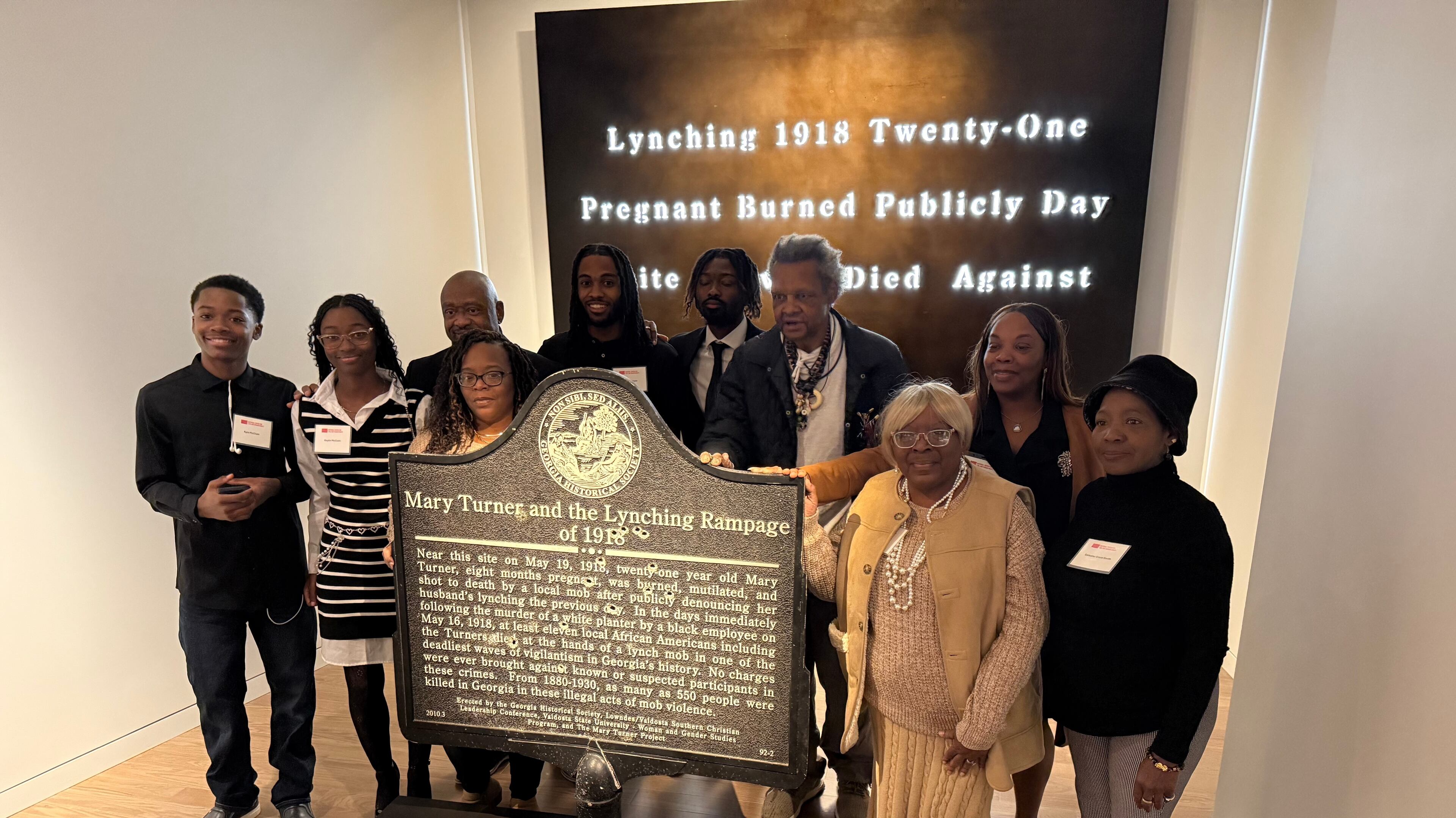 Descendants of Mary Turner, who was lynched in 1918, pose with her historic marker and artist Lonnie Holley, fourth from left, at the National Center for Civil and Human Rights, on Dec. 6, 2025 in Atlanta. (AP Photo/Michael Warren)