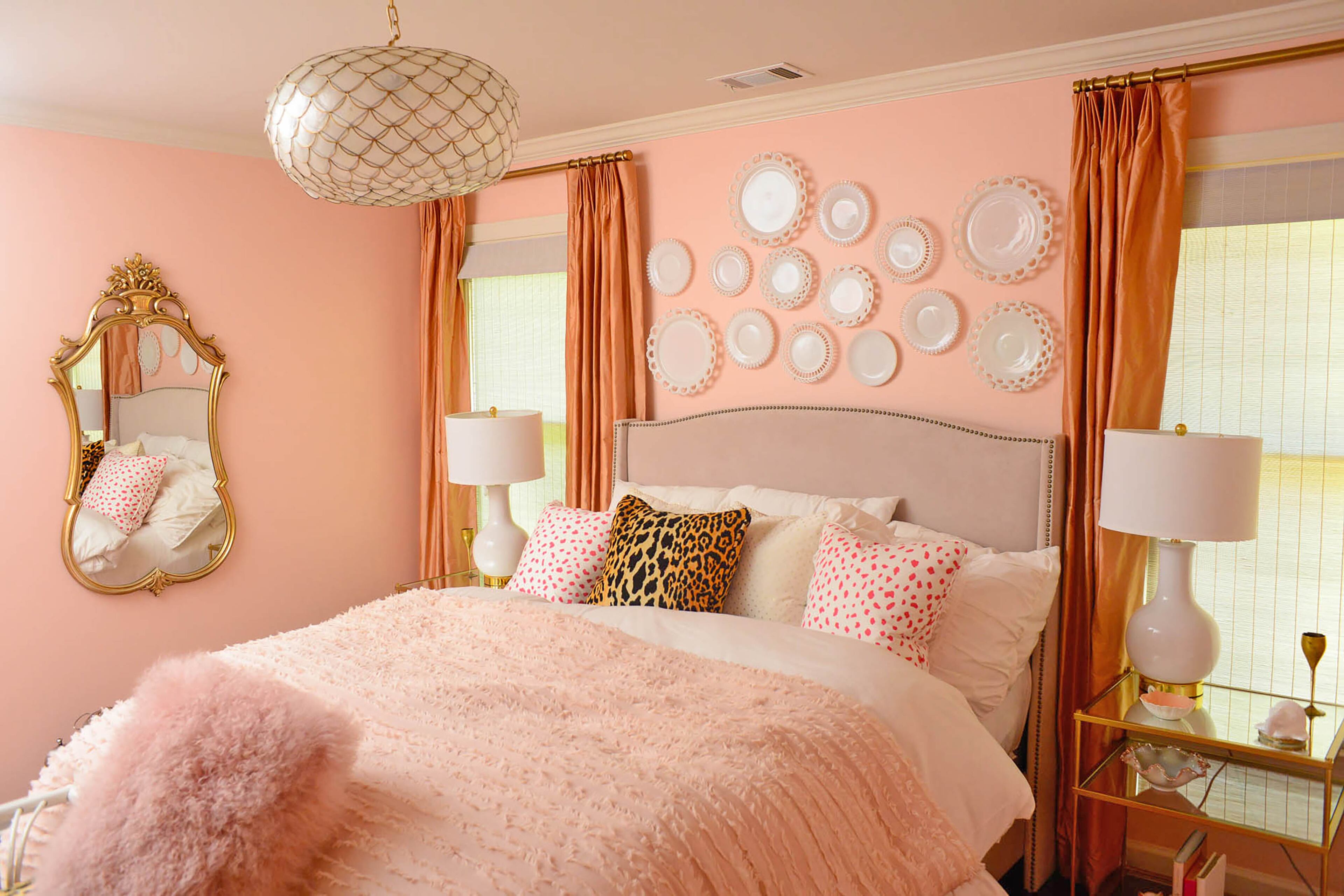 In her 13-year-old daughter's room, Edee arranged vintage milk glass dishes against walls painted Sherwin-Williams Koral Kicks. The gold elements in the mirror, Serena & Lily chandelier made of shells and bedside tables from West Elm elevate the space from childish to stylish.