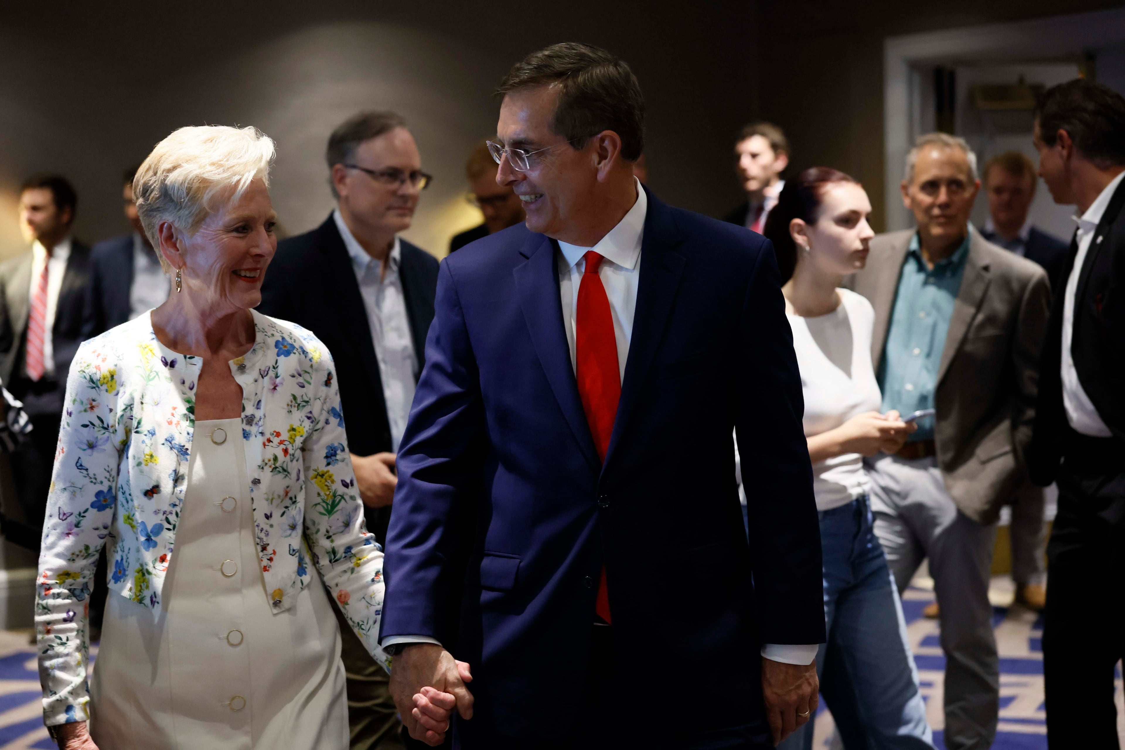 Secretary of State Brad Raffensperger and his wife Tricia Raffensperger hold hands as they enter the hall to speak to supporters during the primary election night watch party at the Waverly Hotel on Tuesday, May 19, 2026. (Miguel Martinez/AJC)