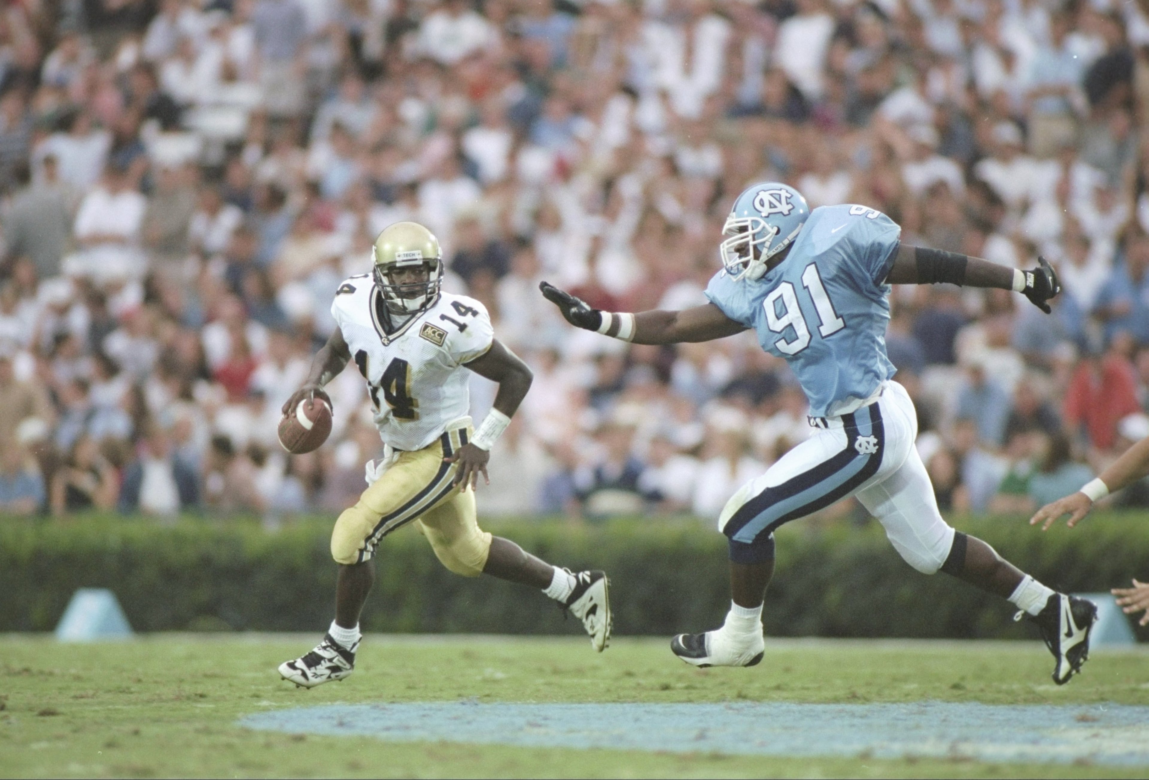 Georgia Tech quarterback Joe Hamilton tries to avoid North Carolina defensive end Mike Pringle on Sept. 21, 1996. Mandatory Credit: Doug Pensinger /Allsport
