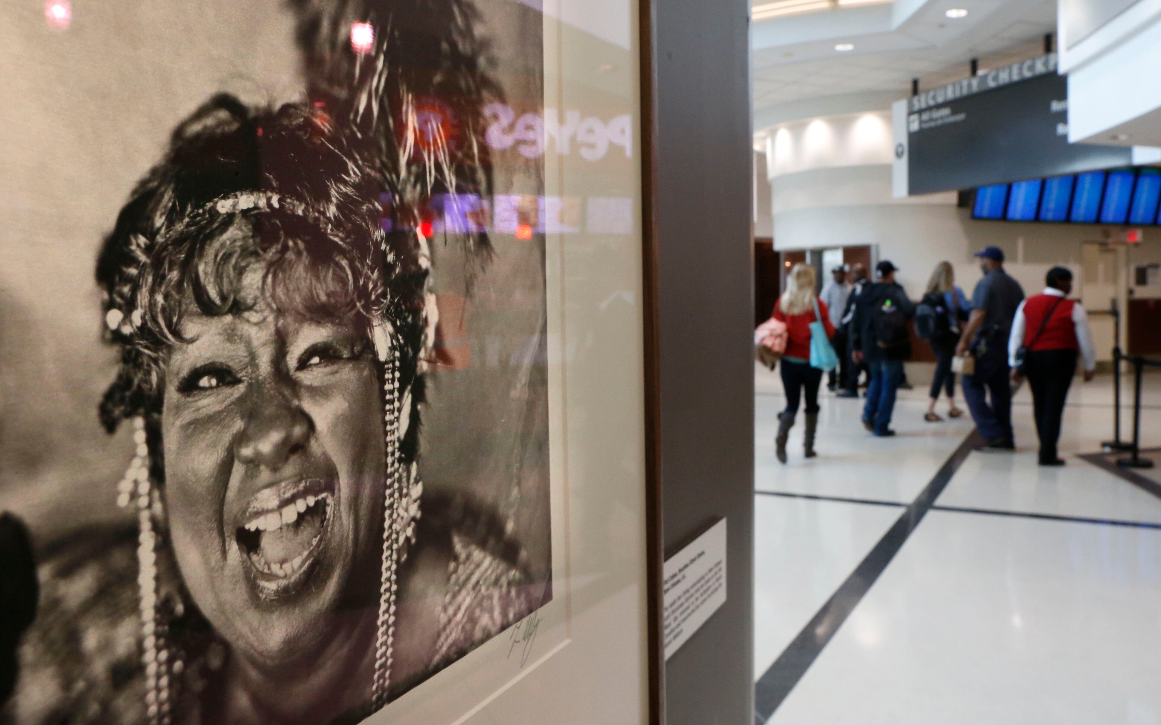 This photo, "Pat Cohen, Bourbon Street Queen", from New Orleans, LA, is among the photographs in the exhibit. A Music Makers Relief Foundation art exhibit debuted in the airport atrium Friday with platinum palladium prints of blues musicians. For 35 years photographer Tim Duffy has photographed Southern musicians and the world in which they live using wet-plate collodion photography. Record crowds are expected along with long lines and delays at Hartsfield-Jackson Atlanta International Airport, the world's busiest airport, which is forecasting some of the biggest increases in traffic it has seen in years. BOB ANDRES / BANDRES@AJC.COM