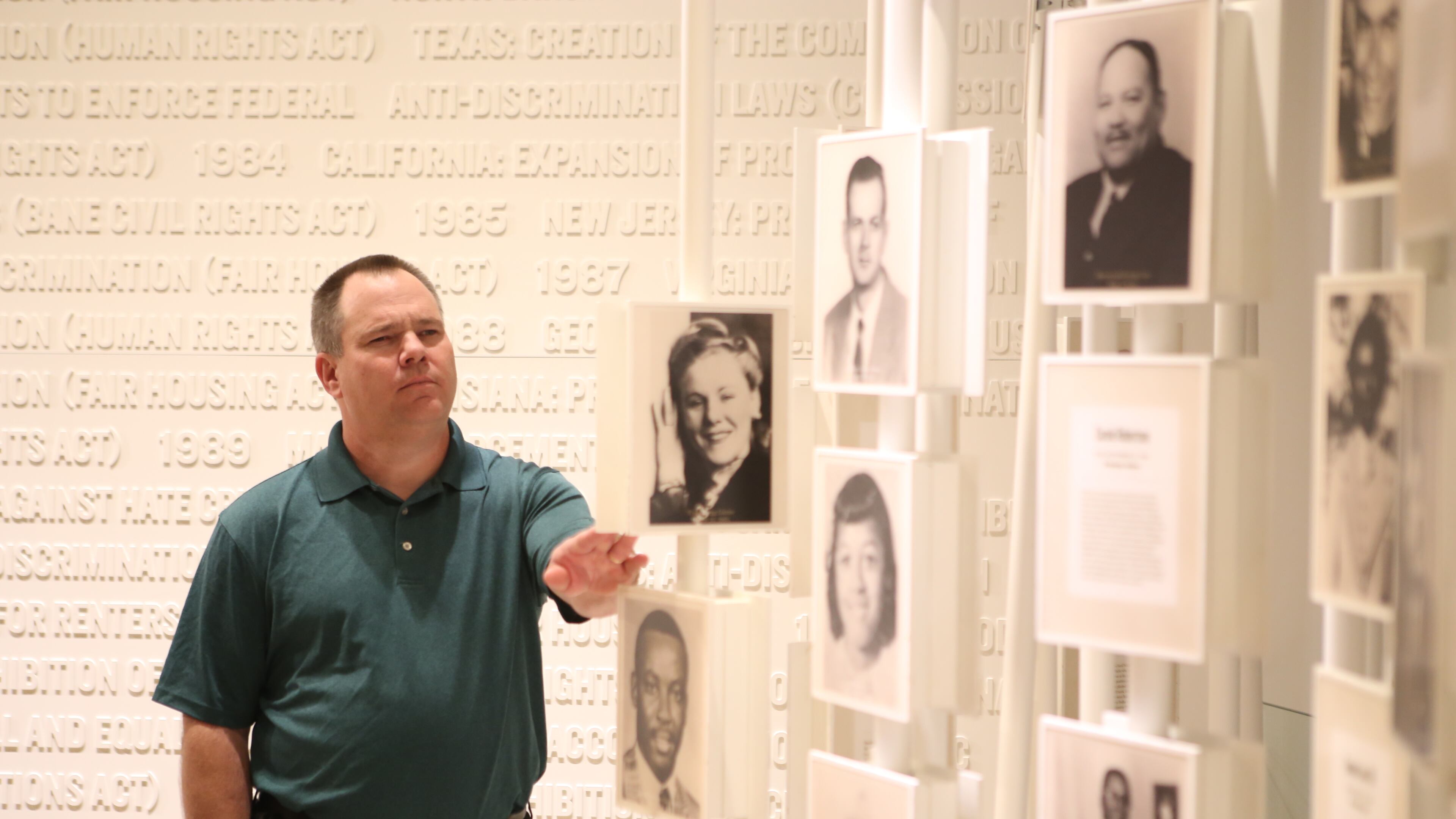 February 14, 2017, Atlanta, Georgia - Gwinnett County Commissioner Tommy Hunter flips a display around to read about a civil rights activist that has been displayed on one of the many pillars in an exhibit at the National Center for Civil and Human Rights in Atlanta, Georgia, on Tuesday, February 14, 2017. (HENRY TAYLOR / HENRY.TAYLOR@AJC.COM)