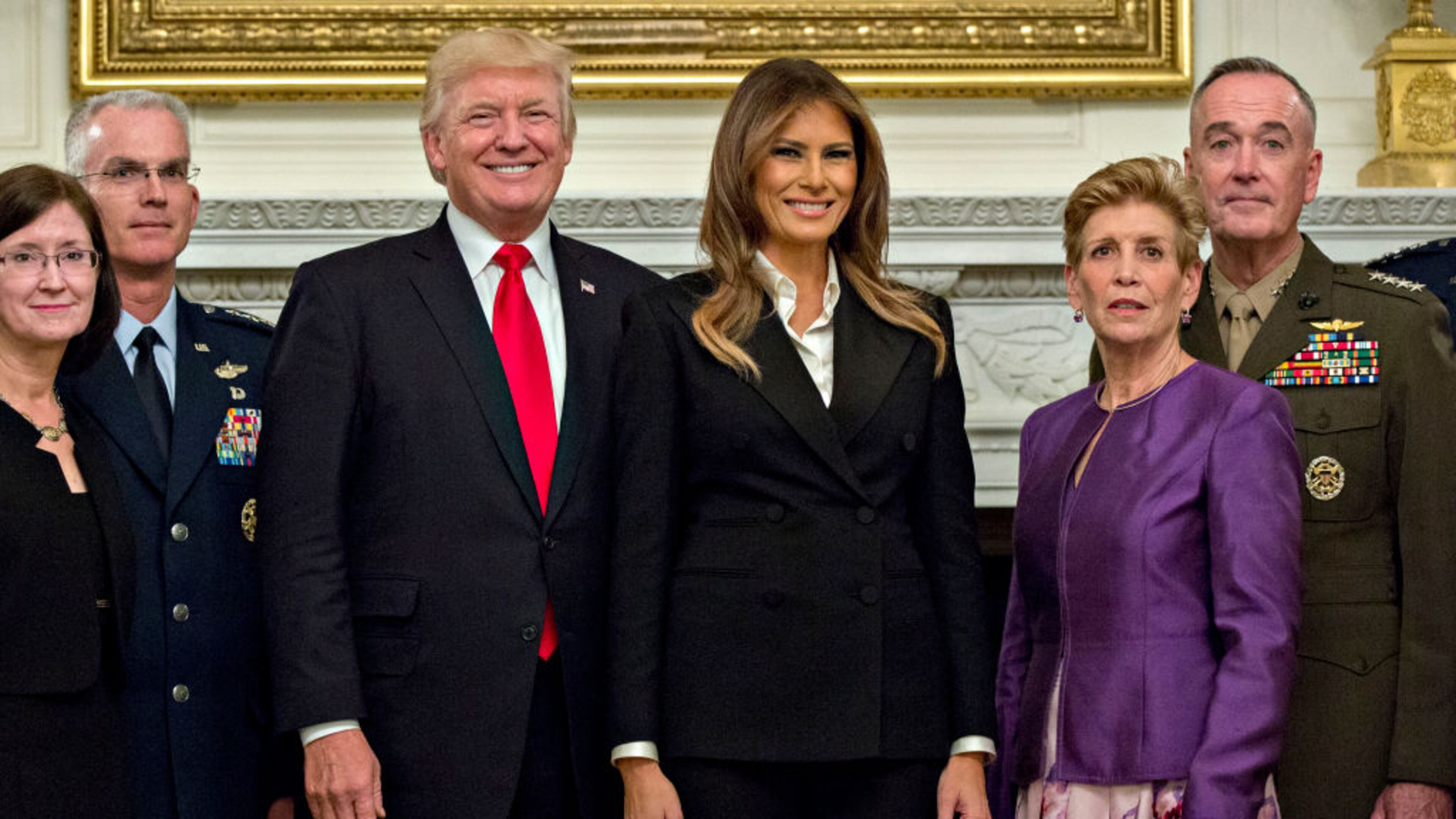 President Donald Trump and first lady Melania Trump pose for pictures with senior military leaders and spouses, including including Gen. Joseph Dunford (right), chairman of the joint chiefs of staff; and General Paul Selva (second from left), vice chairman of the joint chiefs of staff, after a briefing in the State Dining Room of the White House .
