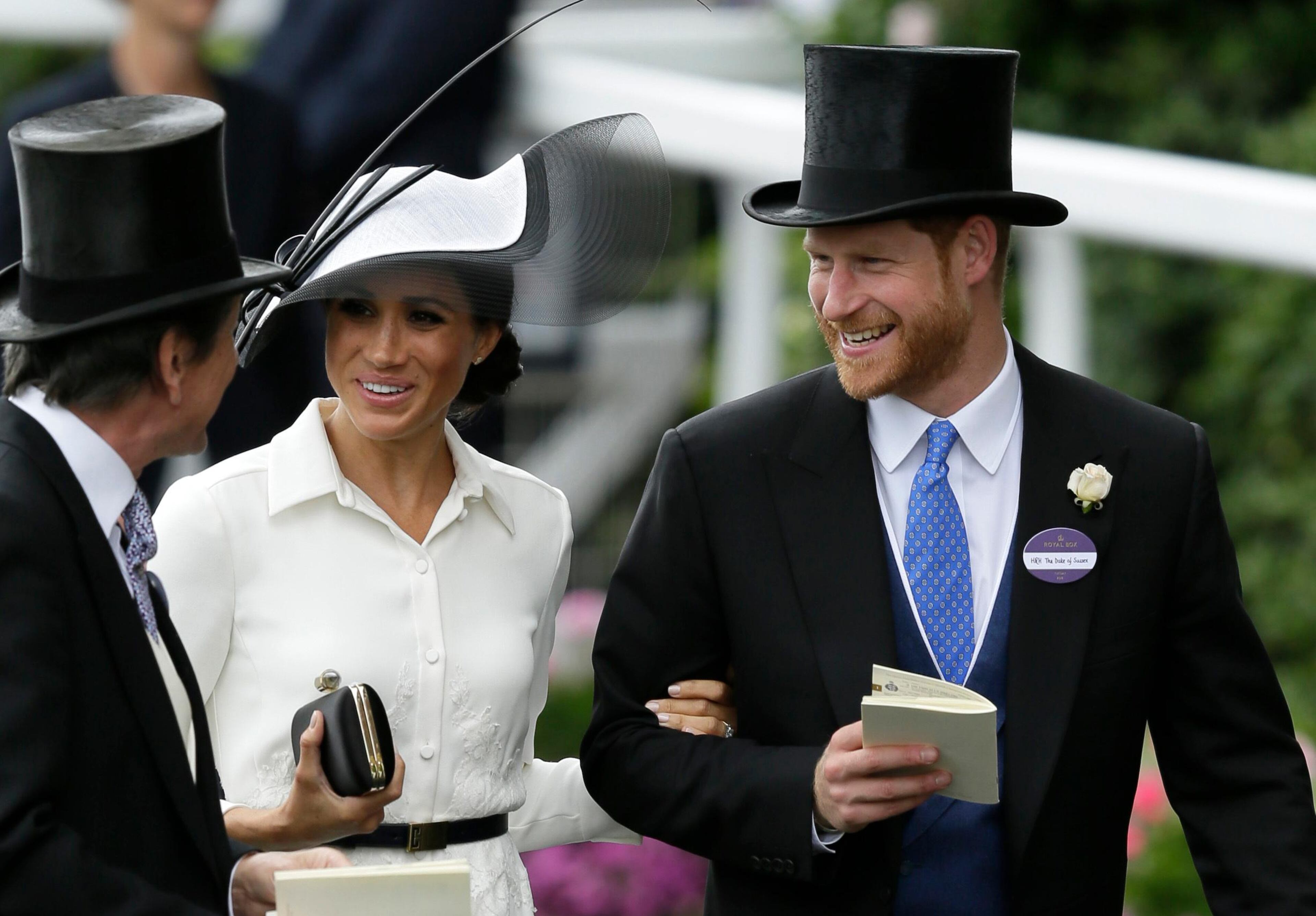 Britain's Prince Harry and Meghan, Duchess of Sussex, arrive on the first day of the Royal Ascot horse race meeting in Ascot, England, Tuesday, June 19, 2018. (AP Photo/Tim Ireland)