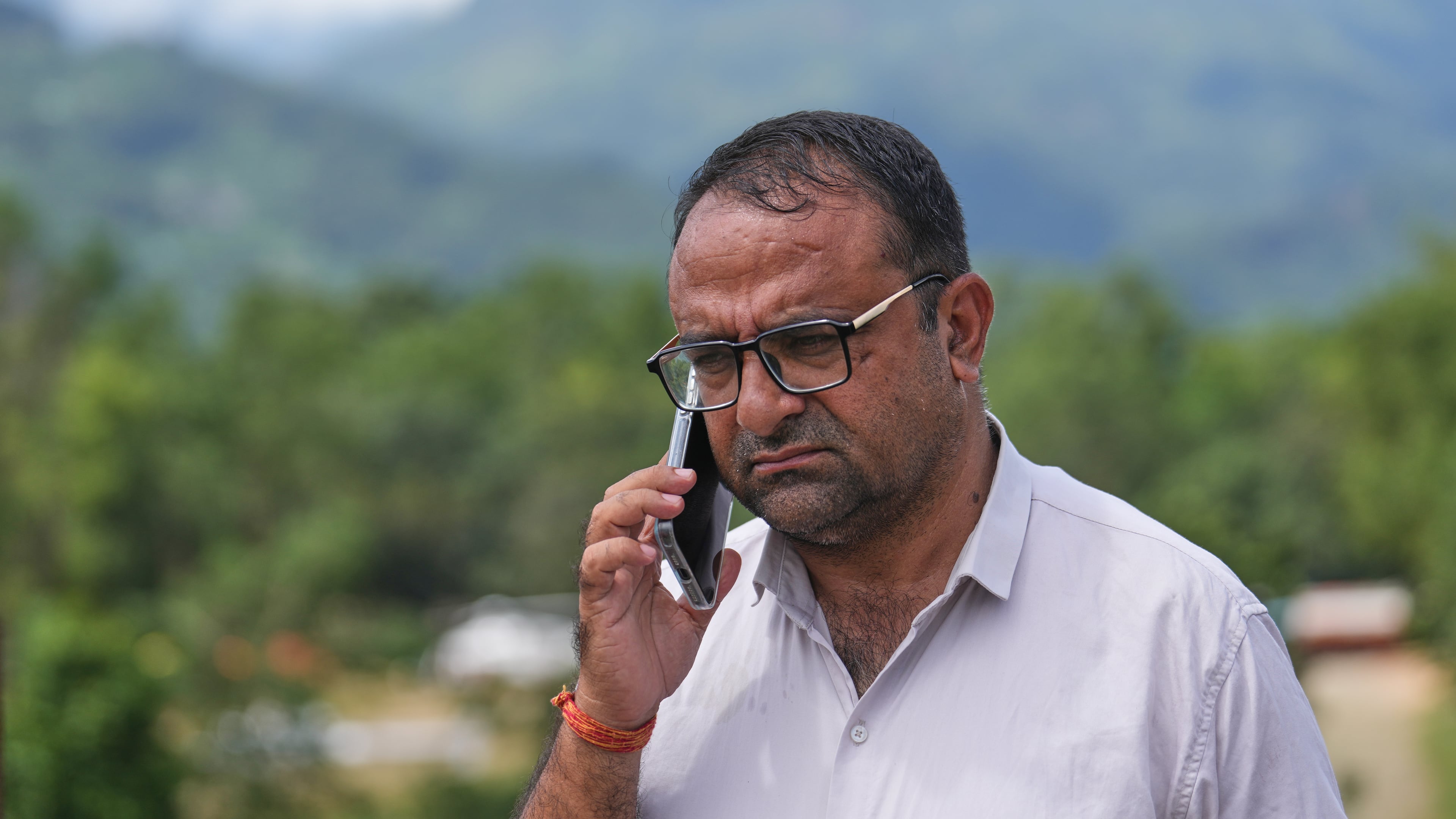 Rajendra Dawadi, a school teacher of Tribhuvan Trishuli Secondary School, talks on his mobile phone in Trishuli Valley in Nepal's Nuwakot district, Monday, Aug. 31, 2026. (AP Photo/Rajesh Kumar Singh)