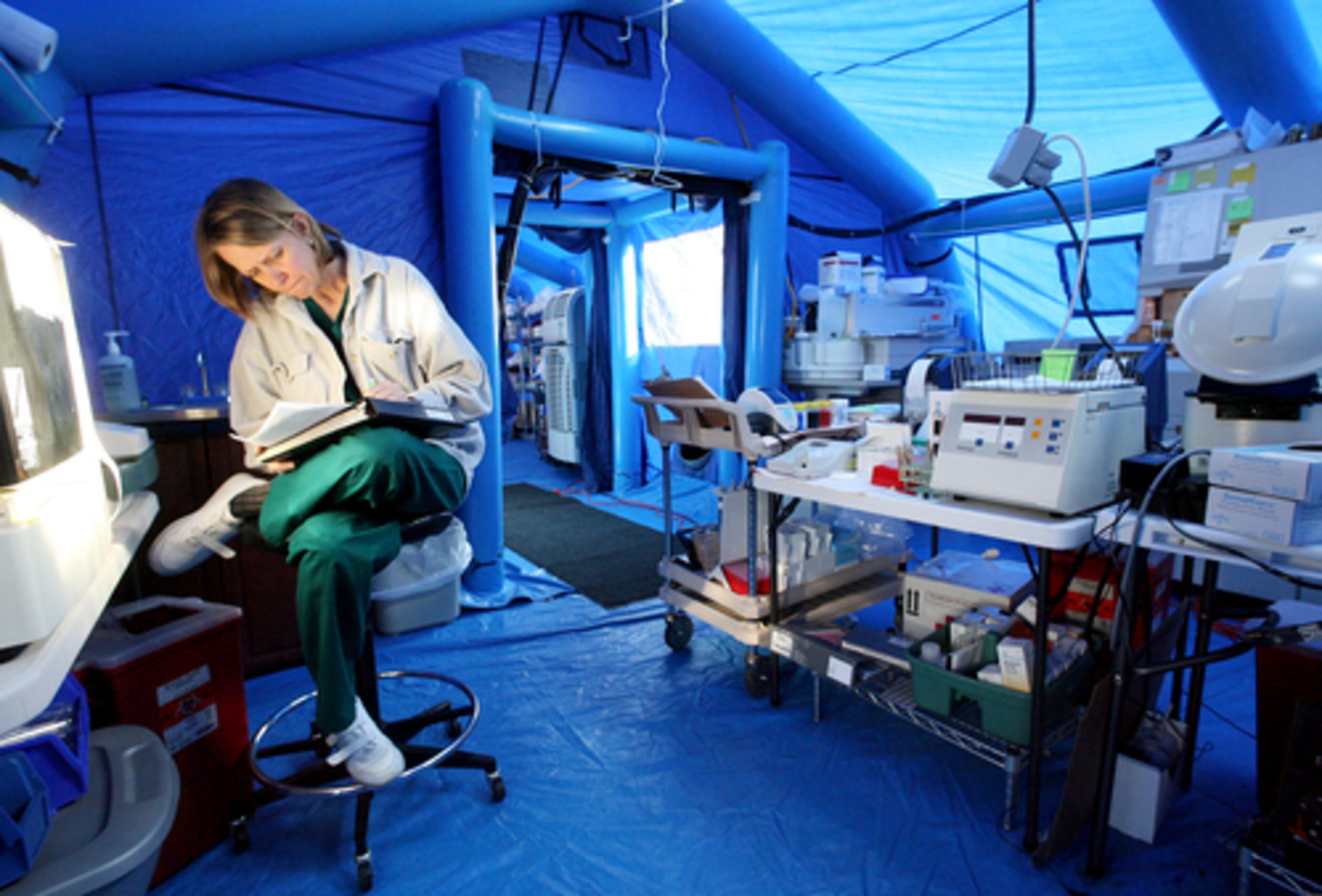 Medical technician Elaine Phillips fills out paperwork in March for a patient's lab results at a temporary lab set up by FEMA.