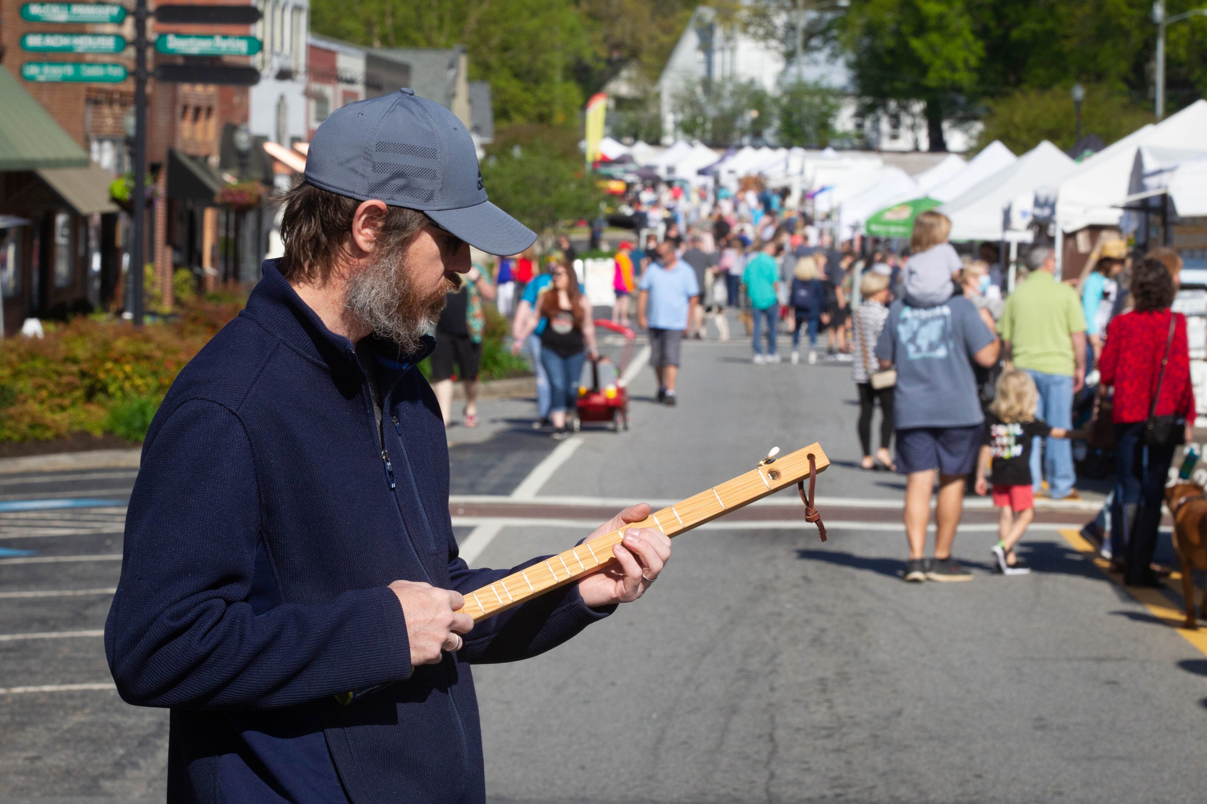 Dustin Headrick plays one of his Spamjos, an instrument made from a can of Spam at the Acworth Art Fest on Sunday, April 11, 2021. (Photo: Steve Schaefer for The Atlanta Journal-Constitution)