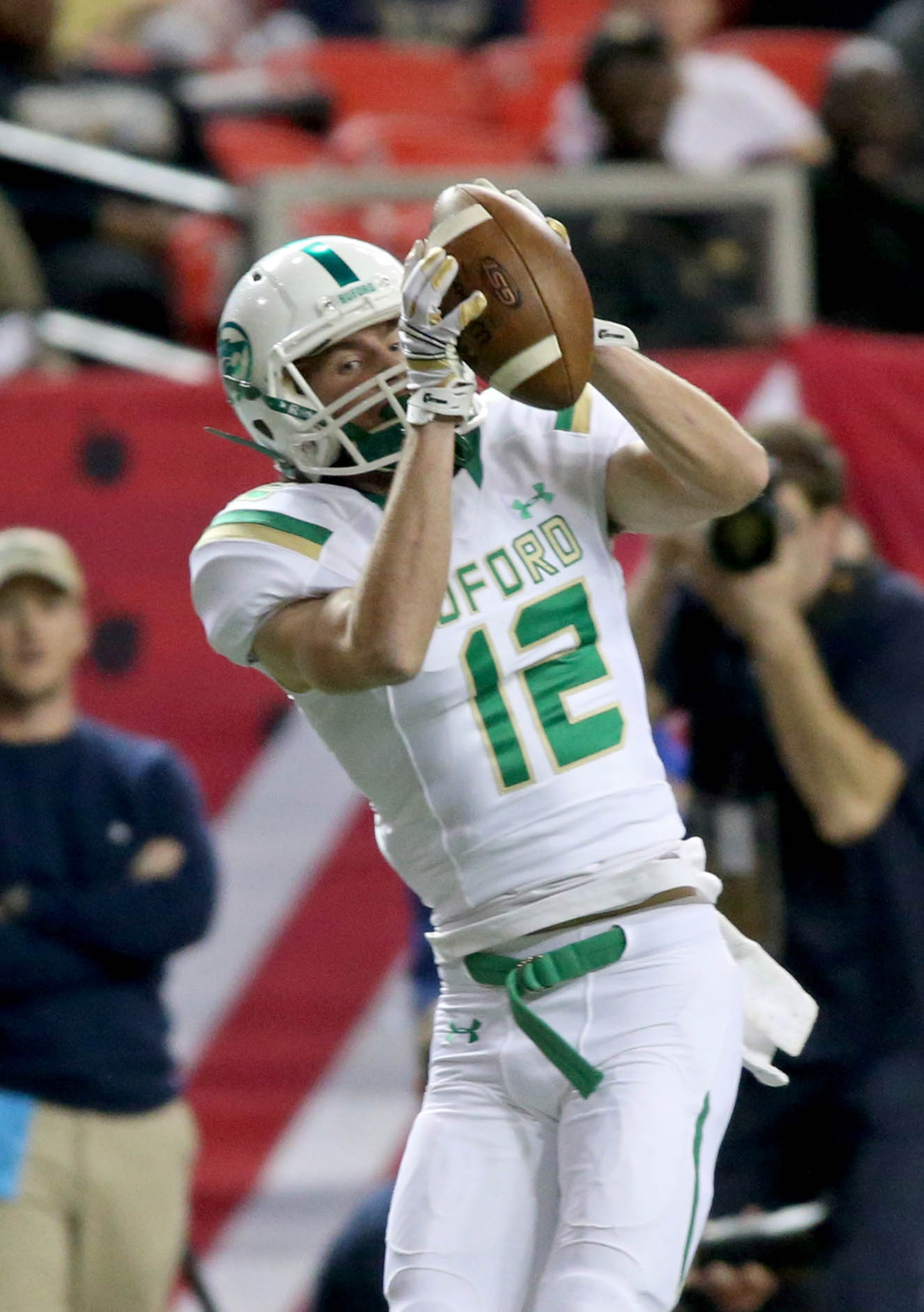 Buford wide receiver Aaron Auer (12) catches a touchdown pass in the first half of their game against St. Pius in the Class AAAA state high school football championship at the Georgia Dome Saturday in Atlanta, Ga., December 13, 2014.