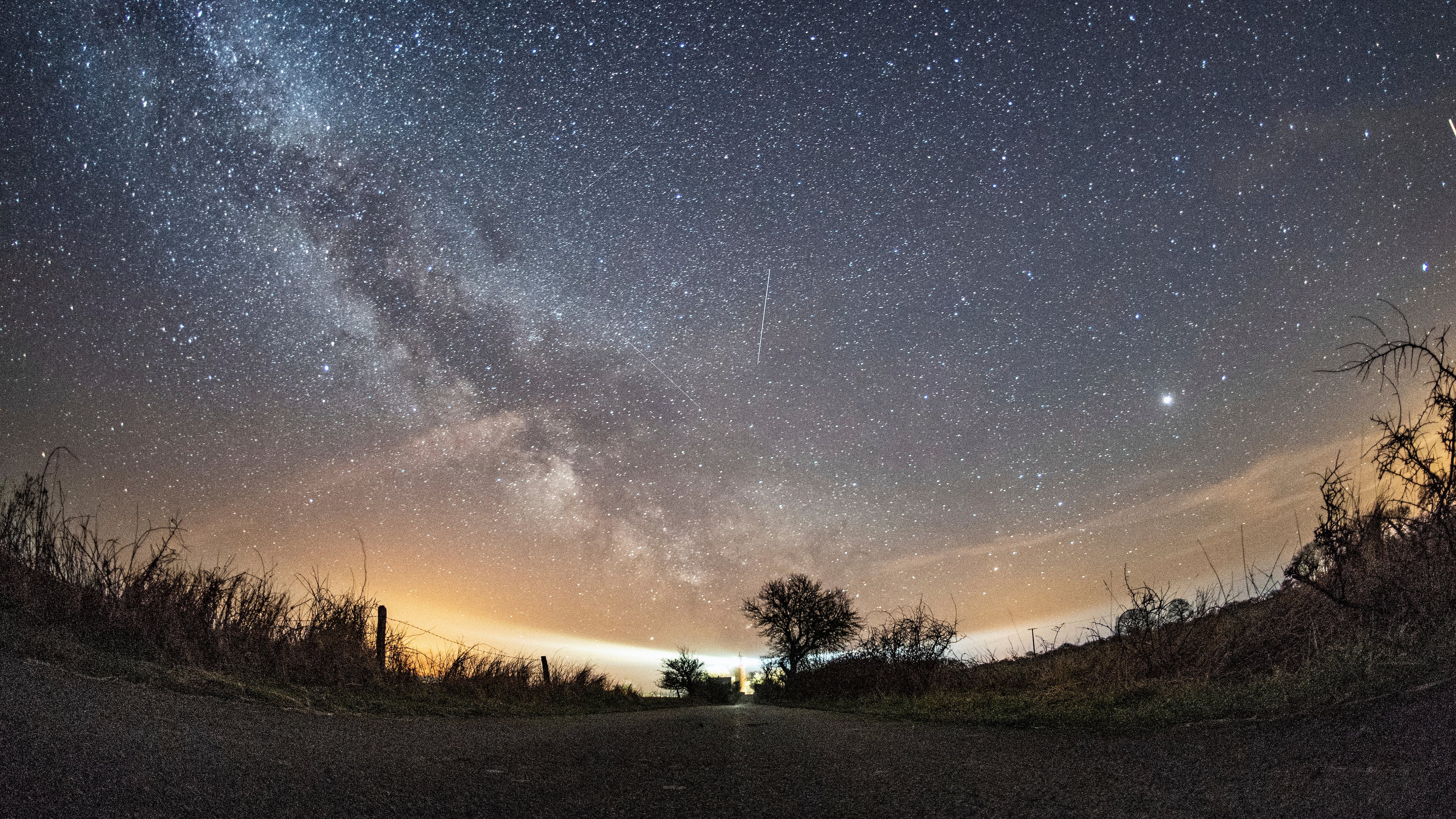 FILE - The milky way and traces of meteors illuminate the sky over Burg on the Baltic Sea island of Fehmarn, northern Germany, April 20, 2018. (Daniel Reinhardt/dpa via AP, File)