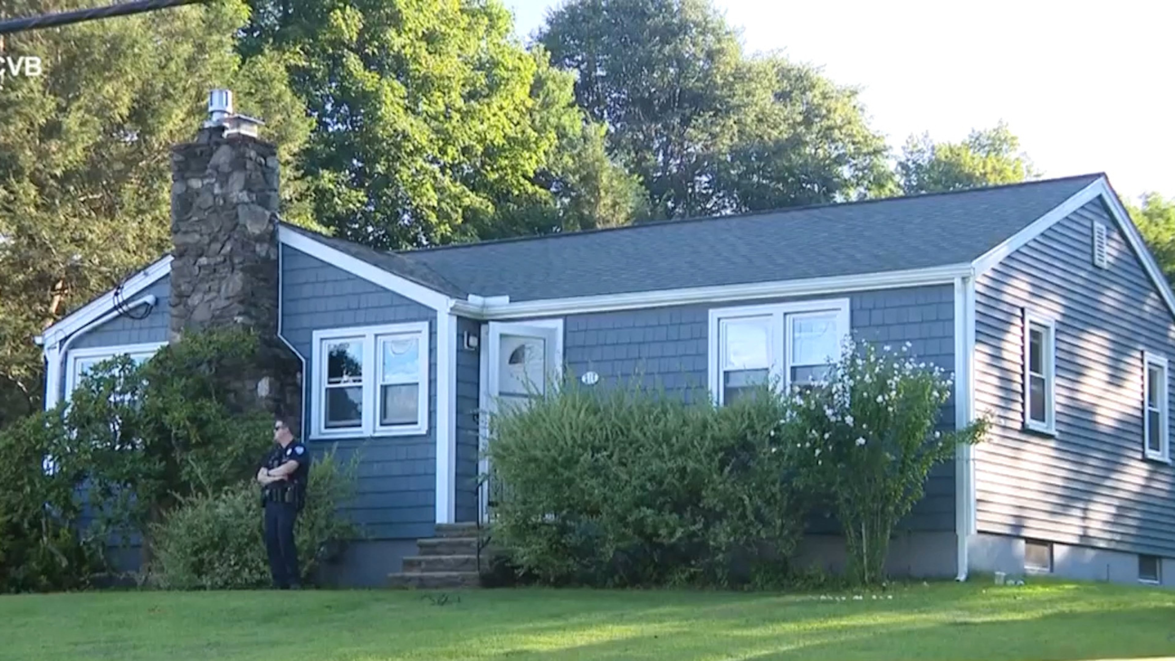 This screen grab made from video provided by WCVB-TV shows a police officer standing guard over a home in Worcester, Mass., Tuesday, Aug. 18, 2026. (WCVB-TV via AP)