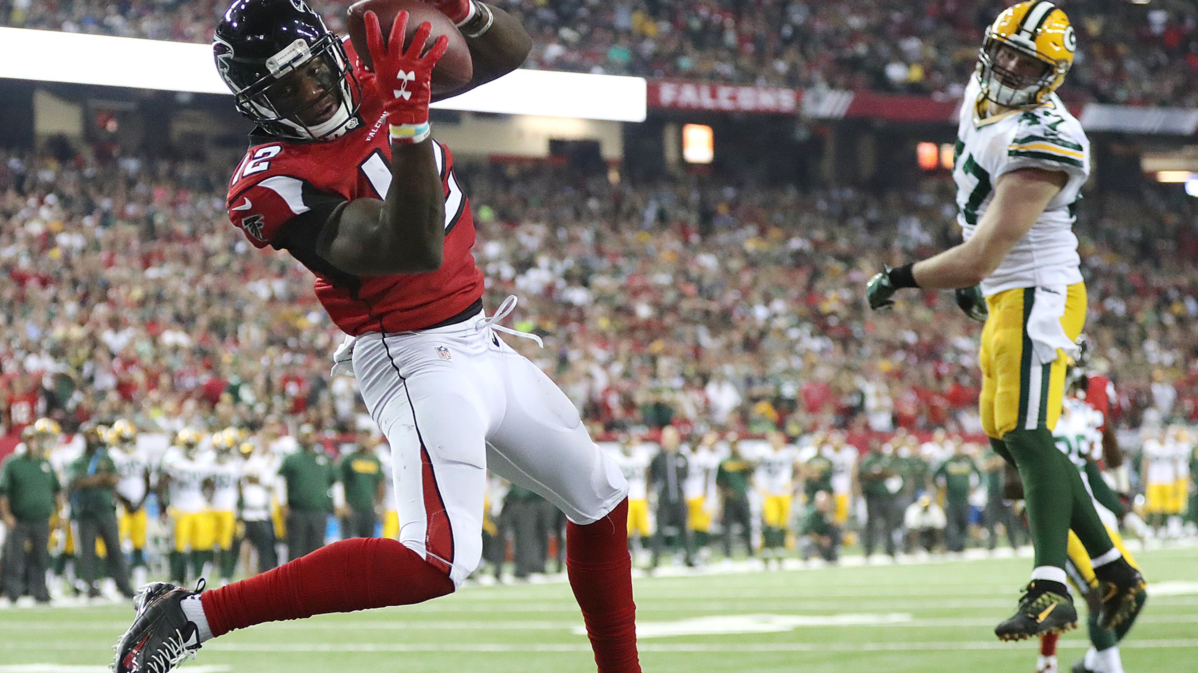 Falcons wide receiver Mohamed Sanu catches a touchdown pass from Matt Ryan past Packers defender Jake Ryan for a 33-32 victory. Curtis Compton /ccompton@ajc.com