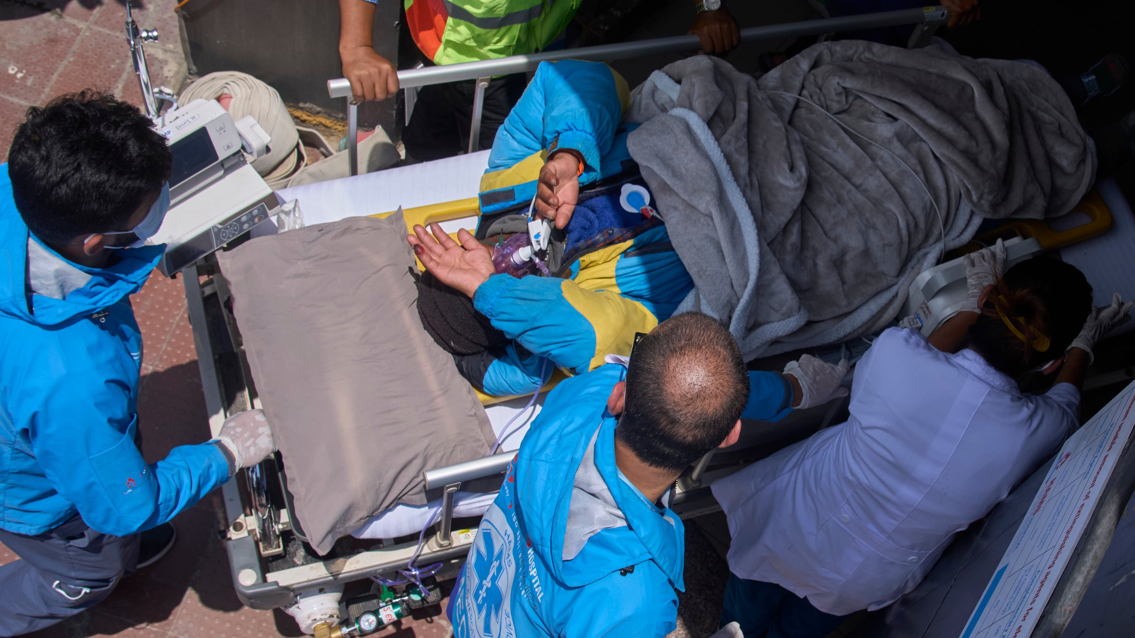 Medics take Dawa Sherpa, a mountain guide who had been missing for several days in the Everest region, for treatment after he arrived at HAMS Hospital in Kathmandu, Nepal, Thursday, June 4, 2026. (AP Photo/Niranjan Shrestha) CORRECTION: Corrects hospital name to HAMS not Grande