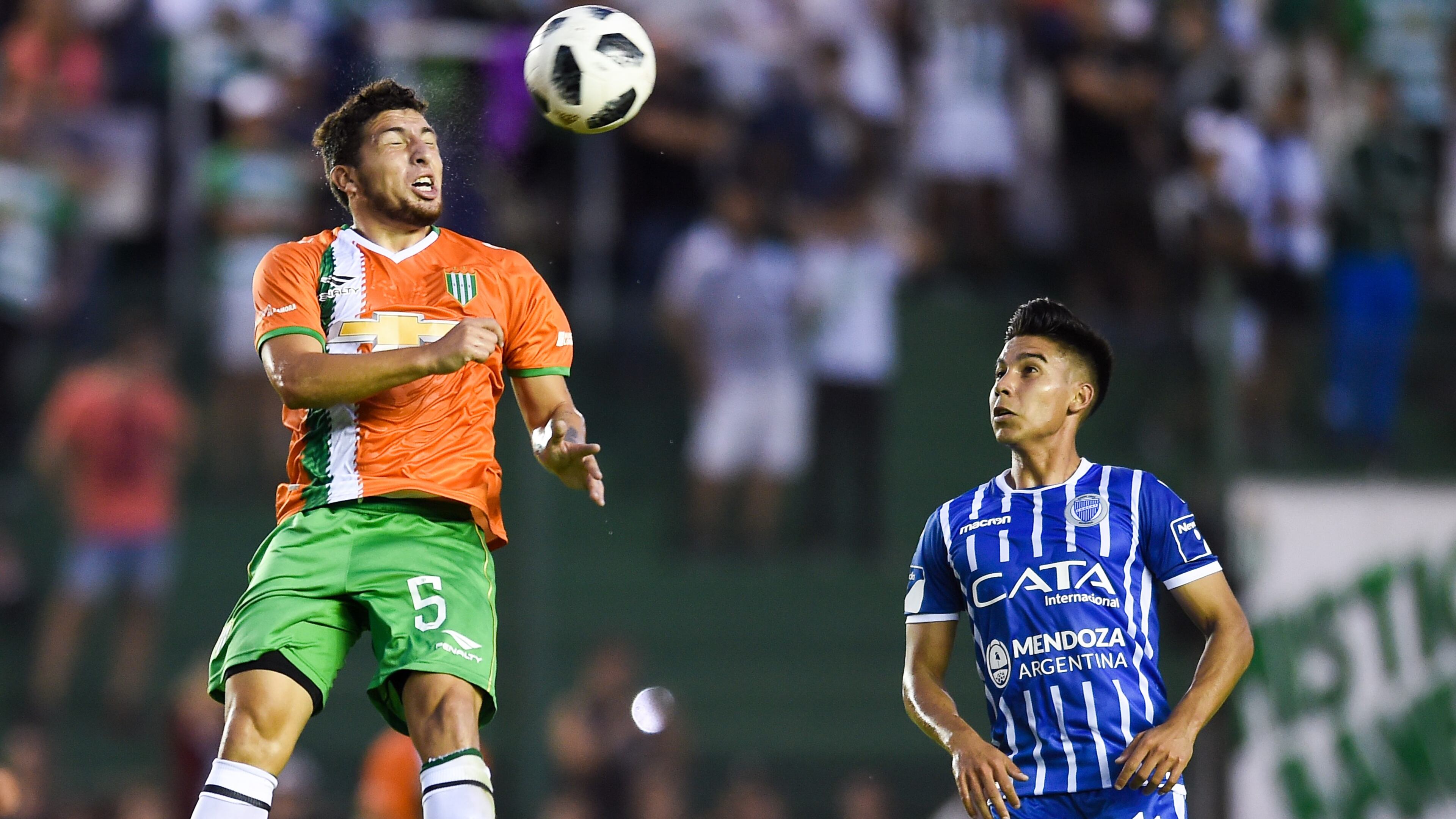 Eric Remedi of Banfield heads the ball against Guillermo Fernández of Godoy Cruz during a match between Banfield and Godoy Cruz as part of Argentina Superliga 2017/18 at Florencio Sola Stadium on April 21, 2018 in Buenos Aires, Argentina.