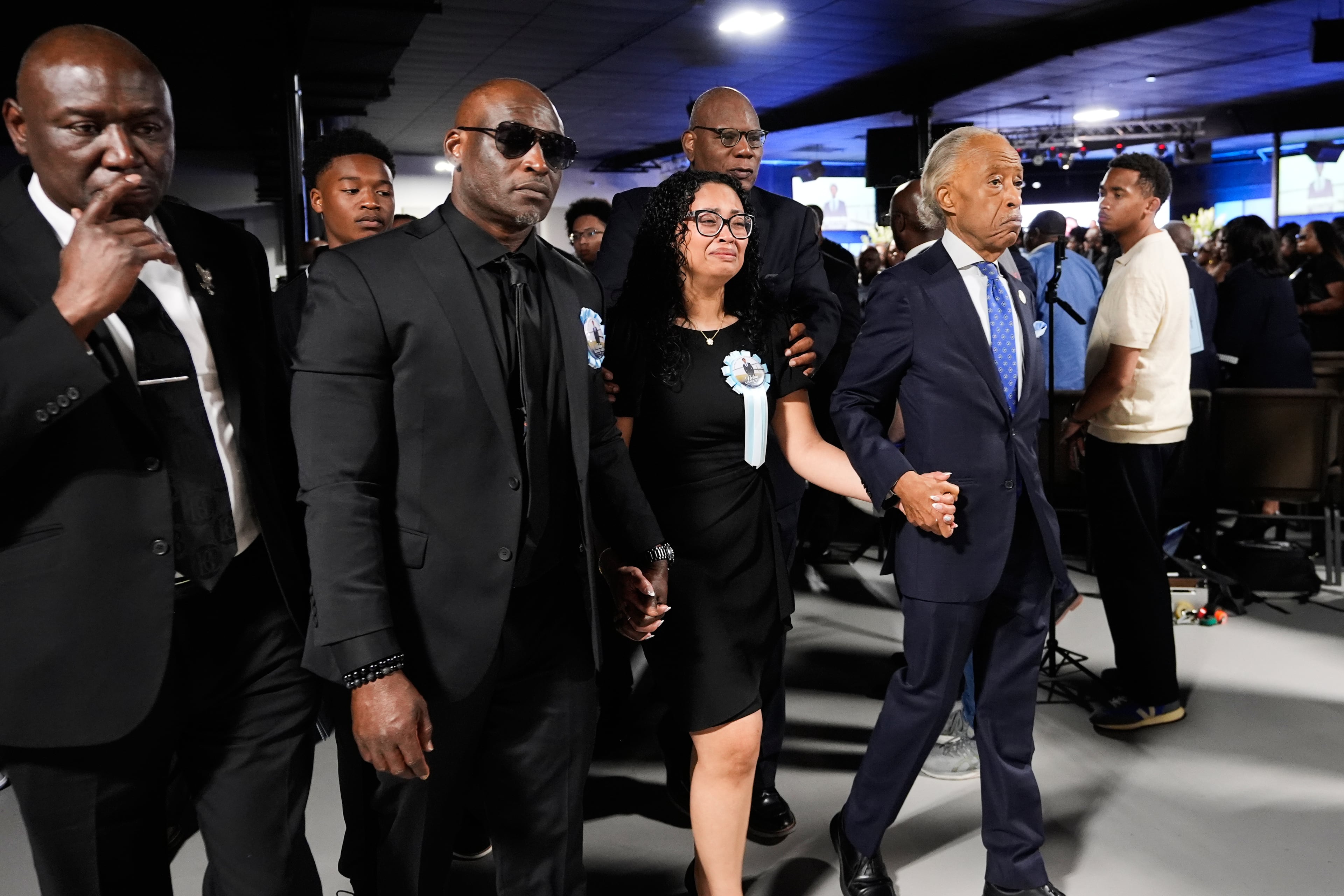 Christine Wonsley, center, walks with Rev. Al Sharpton, right, her husband Elmore, second from left, and attorney Ben Crump, left, during a memorial service for her son Nolan Xavier Wells, an 18-year-old found dead after taking a July 4 boat trip with friends, Monday, July 20, 2026, in Ocean Springs, Miss. (Gerald Herbert/AP)