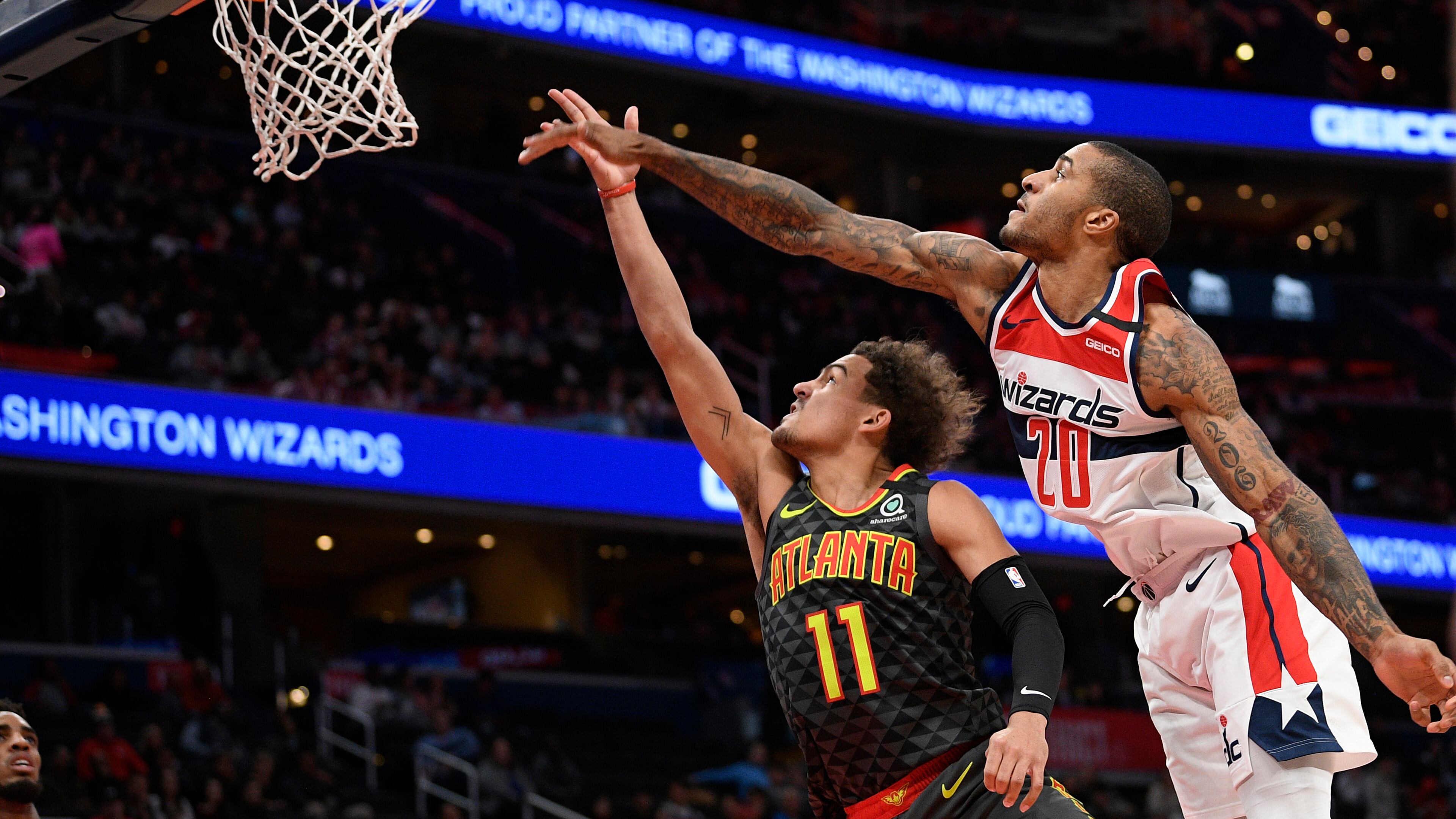 Atlanta Hawks guard Trae Young (11) goes to the basket next to Washington Wizards guard Gary Payton II (20) during the first half of an NBA basketball game, Friday, Jan. 10, 2020, in Washington. (AP Photo/Nick Wass)