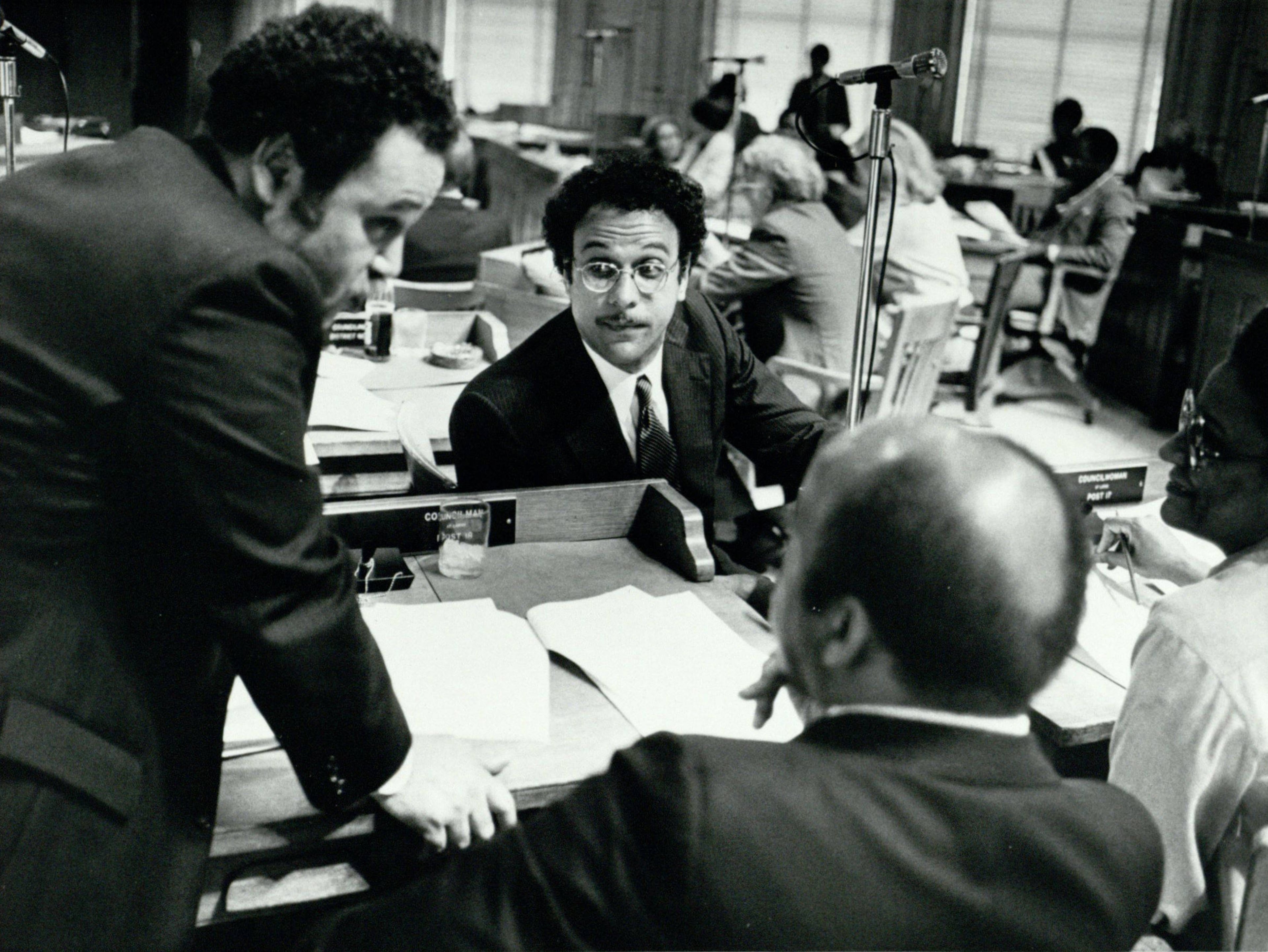 In this undated photo from the 1980s, Atlanta City Council members Jim Maddox (left), Bill Campbell (middle), and John Lewis (foreground) discuss rezoning legislation. Campbell and Lewis, along with Myrtle Davis, were elected to the council the same year, giving the council a black majority for the first time in the city’s history. (Michael Pugh / AJC Archive at GSU Library AJCP142-026z)