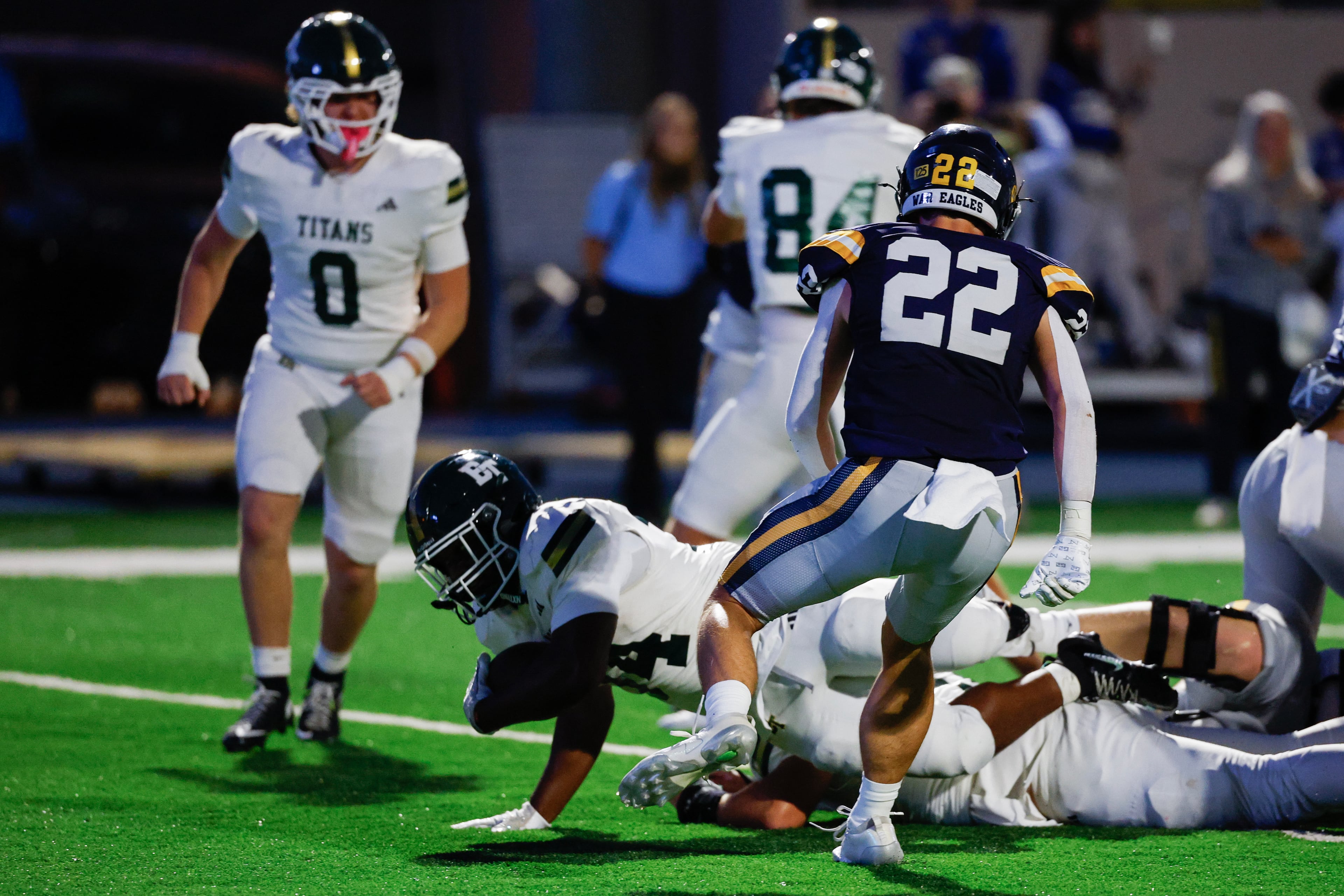 Blessed Trinity running back MJ Craft (center) rushes for a touchdown against Marist’s Hunter Williams on Friday, Sept. 25, 2026, in Atlanta. (Erik S. Lesser for the AJC)