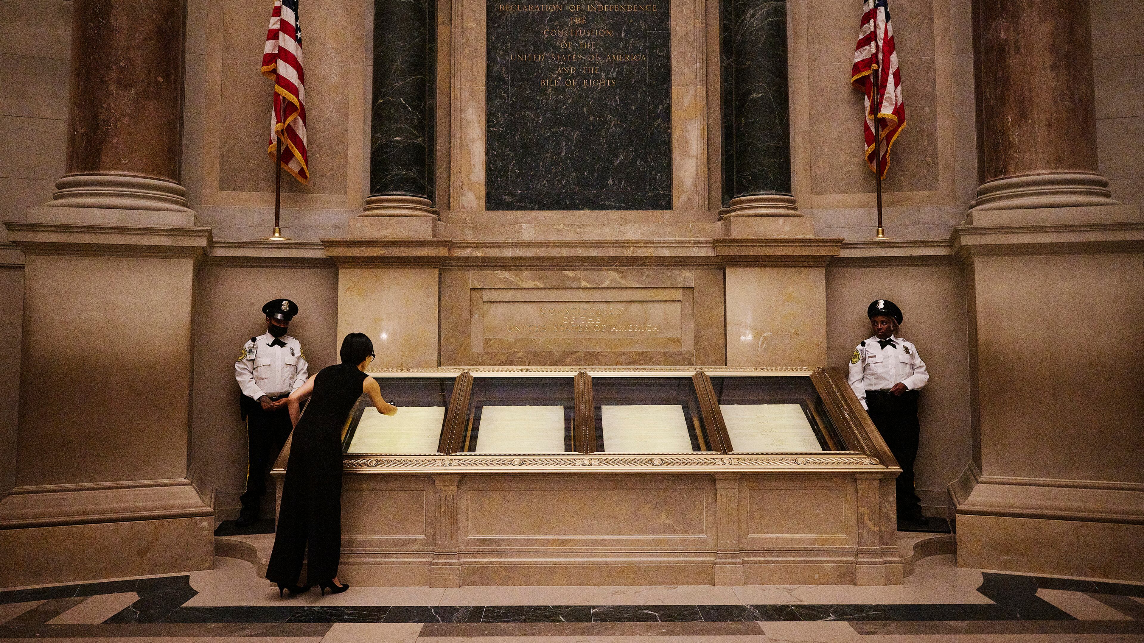 The Declaration of Independence is displayed at the National Archives under dim lights to slow the degradation of the ink. (Jared Soares/The New York Times)