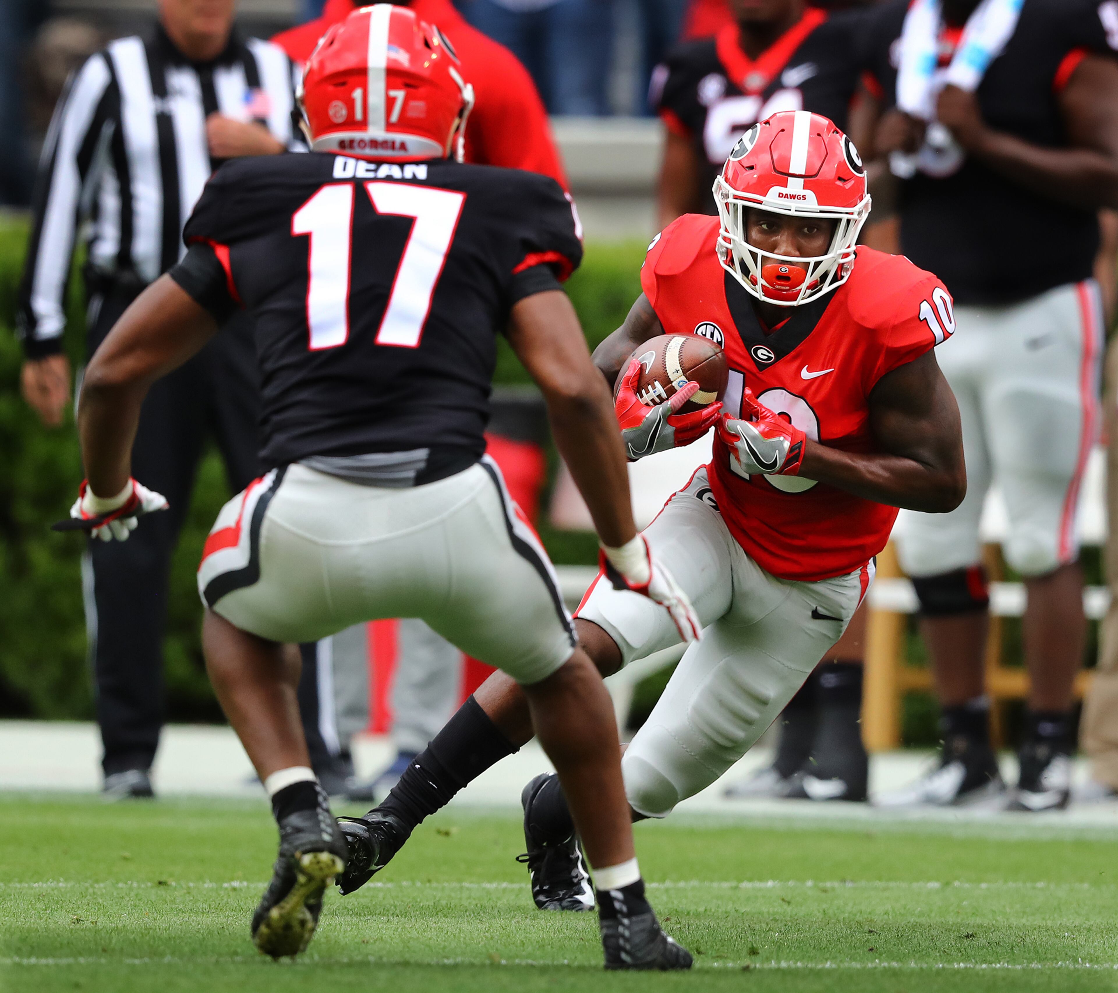 Georgia wide receiver Kearis Jackson makes a move against linebacker Nakobe Dean after catching a pass in the annual G-Day football game on Saturday, April 20, 2019, in Athens. Curtis Compton/ccompton@ajc.com