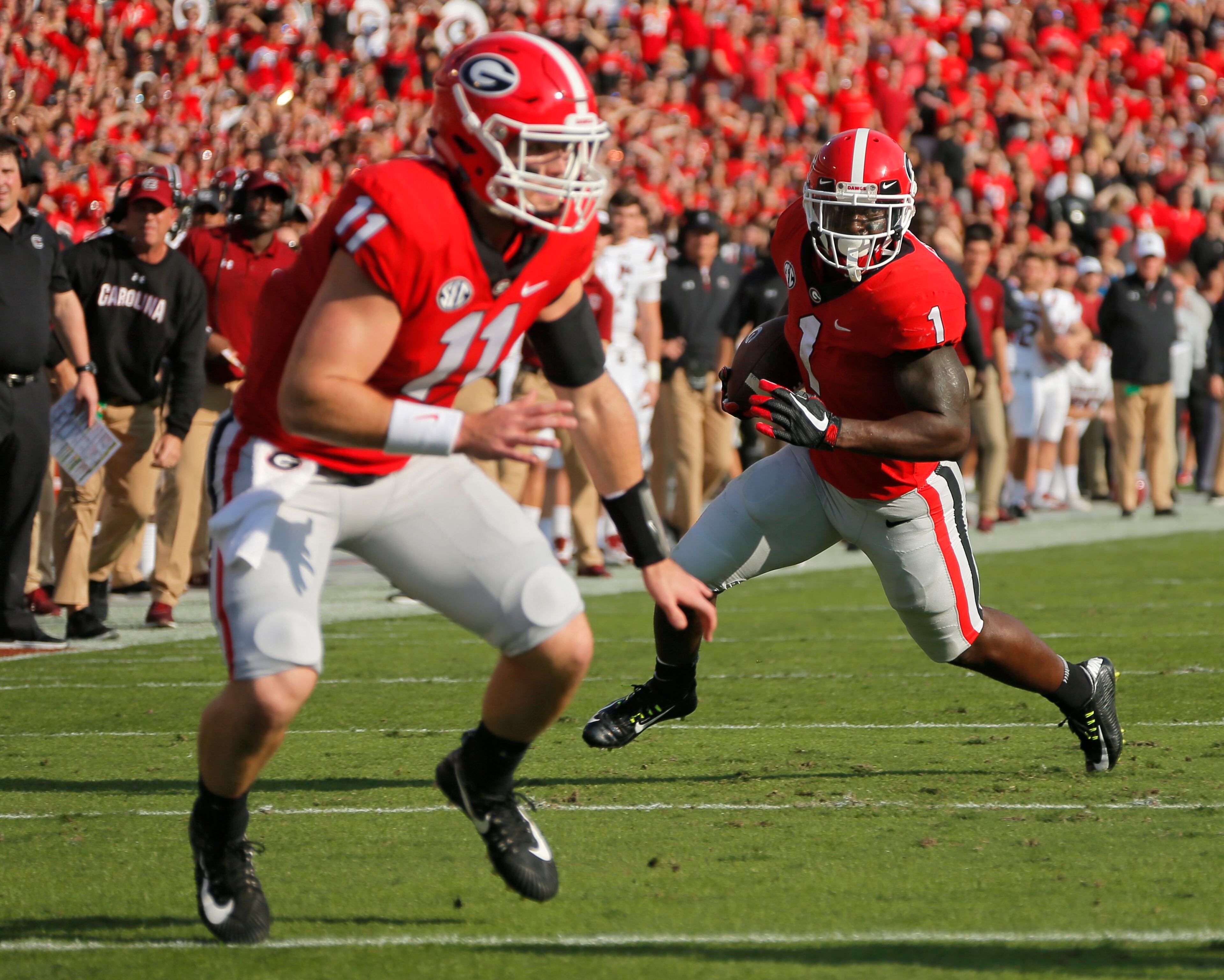 11/4/17 - Athens - Georgia Bulldogs running back Sony Michel (1) runs for UGA's first TD with some blocking from Georgia Bulldogs quarterback Jake Fromm (11). NCAA football game between the University of Georgia Bulldogs and the University of South Carolina Gamecocks BOB ANDRES /BANDRES@AJC.COM
