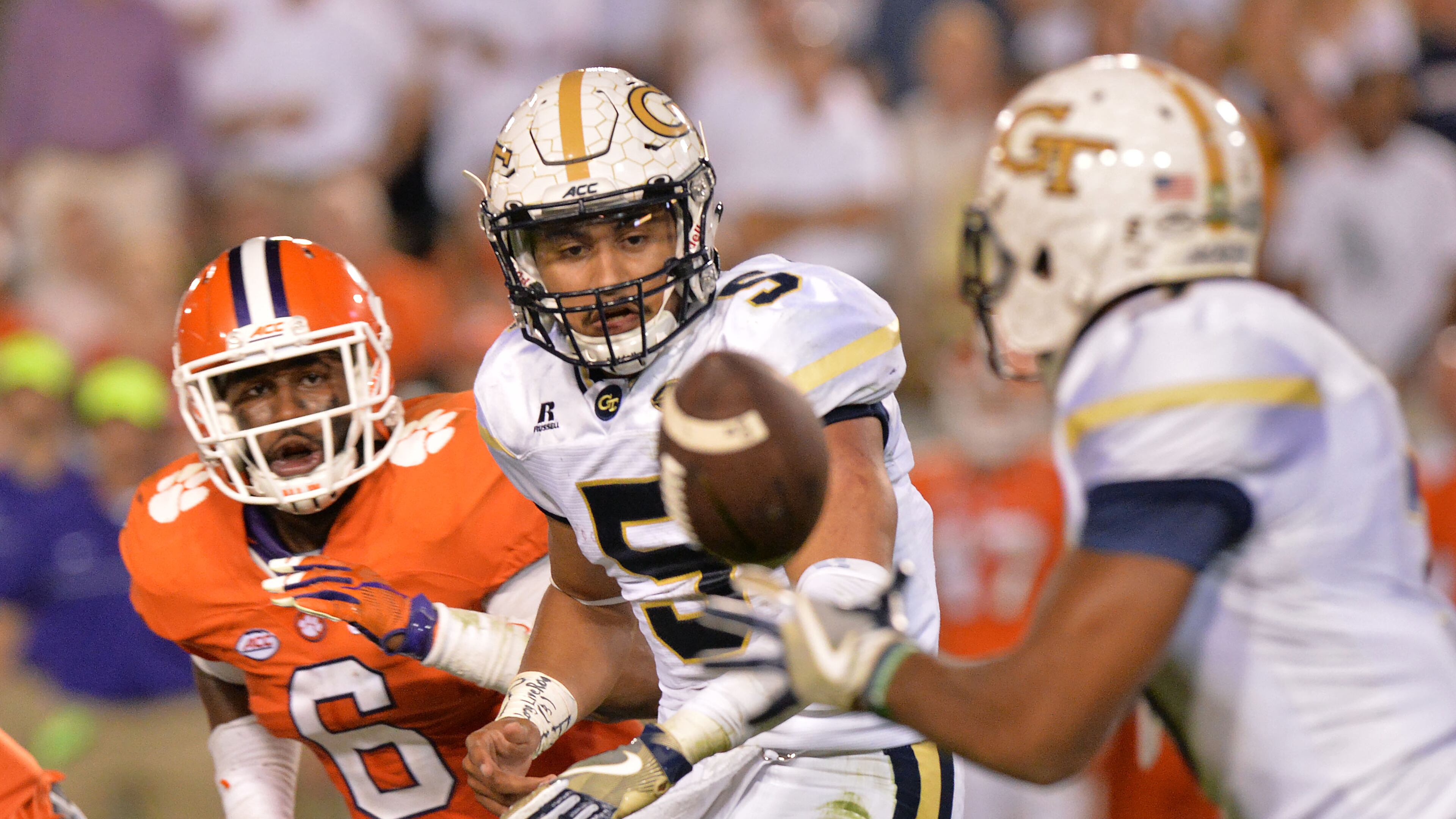 September 22, 2016 Atlanta - Georgia Tech Yellow Jackets quarterback Justin Thomas (5) tosses a football to Georgia Tech Yellow Jackets running back Isiah Willis (right) in the second half at Bobby Dodd Stadium on Thursday, September 22, 2016. Clemson Tigers won 26 - 7 over the Georgia Tech Yellow Jackets. HYOSUB SHIN / HSHIN@AJC.COM